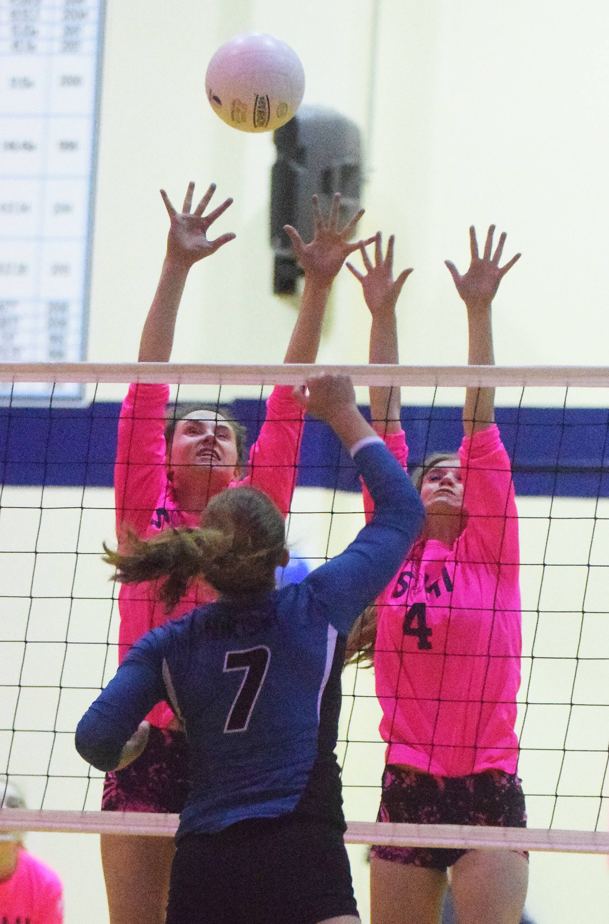 Soldotna juniors Aliann Schmidt and Kodi McGillivray (4) team up to block Nikiski junior Bethany Carstens Tuesday evening at Soldotna High School. (Photo by Joey Klecka/Peninsula Clarion)