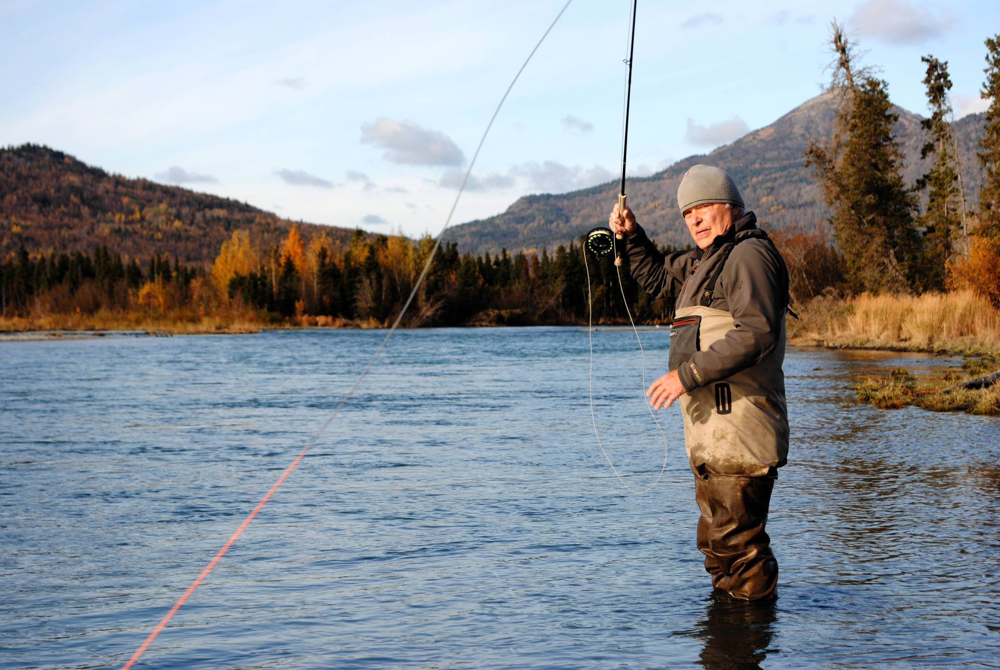 TOP: Brant Koetting, a fishing guide with Tower Rock Lodge, holds out one of his bead selections for fishing the Upper River Kenai in Alaska on Oct. 11, 2017. (Photo by Kat Sorensen/Peninsula Clarion)  ABOVE: Mike Tuhy, owner and operator of the Tower Rock Lodge in Kenai casts for trout in the Upper River Kenai on Oct. 11. (Photo by Kat Sorensen/Peninsula Clarion) BELOW: Novice fly angler and writer of this story holds out a rainbow trout she managed to catch on her first fly fishing trip with Michael Tuhy and Brant Koetting of Tower Rock Lodge in the Upper River Kenai in Alaska on Oct. 11. (Photo by Brant Koetting)