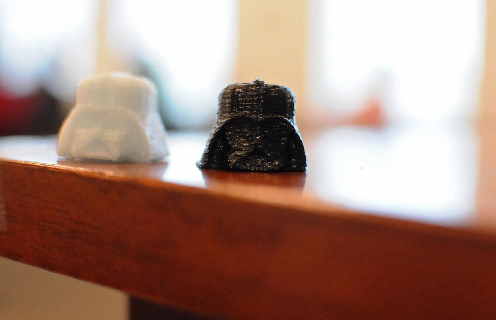3D-printed plastic replicas of Darth Vader’s helmet from the “Star Wars” movie sit on a table at the Soldotna Public Library on Thursday, Oct. 19, 2017 in Soldotna, Alaska. The library acquired a 3D printer, which prints three-dimensional objects in plastic based on submitted patterns, in July and has opened it to public use. It’s currently free, supported by the Soldotna Library Friends, with a suggested donation of $3 per print. (Photo by Elizabeth Earl/Peninsula Clarion)