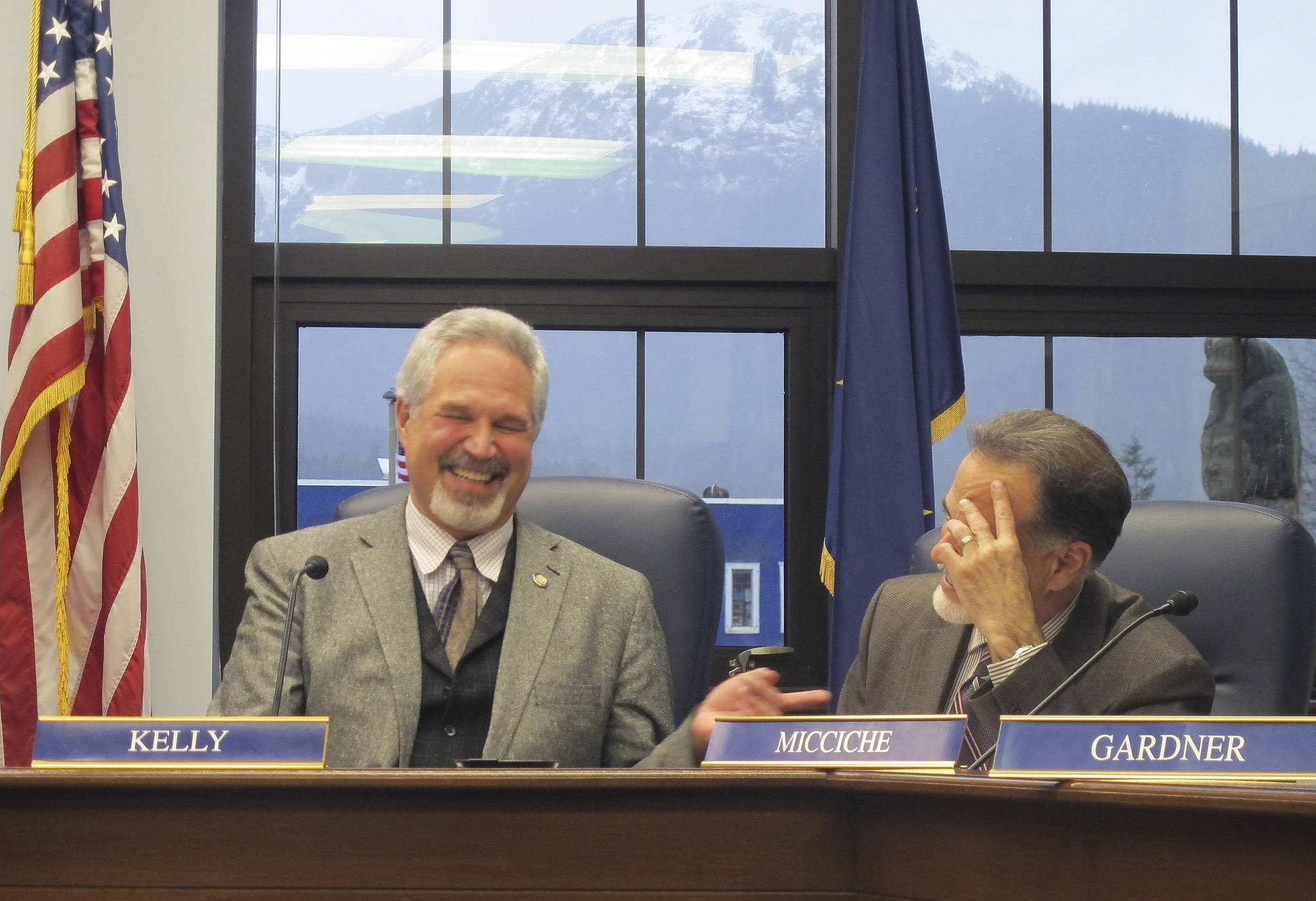 Alaska state Senate President Pete Kelly, left, laughs with Sen. Peter Micciche following a Senate committee meeting on Monday in Juneau. Legislators on Monday convened for their fourth special session of the year, this one called by the governor to address taxes and crime. (AP Photo/Becky Bohrer)