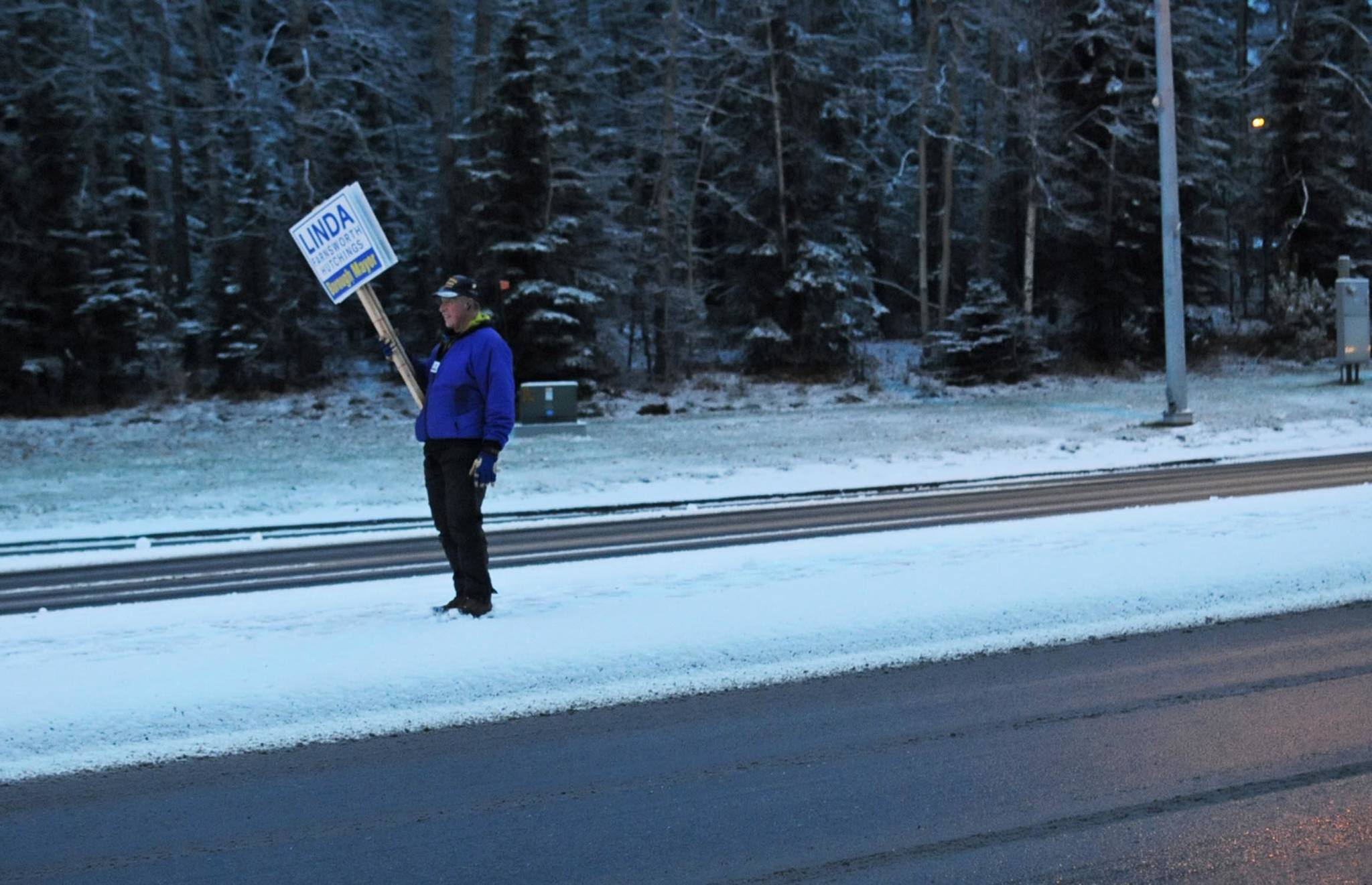 A man waves a sign supporting Kenai Peninsula Borough mayoral candidate Linda Hutchings from the median on the Sterling Highway near the intersection with the Kenai Spur Highway on Tuesday, Oct. 24, 2017 in Soldotna, Alaska. Kenai Peninsula voters chose between Hutchings and candidate Charlie Pierce in the mayoral runoff election Tuesday. (Photo by Elizabeth Earl/Peninsula Clarion)