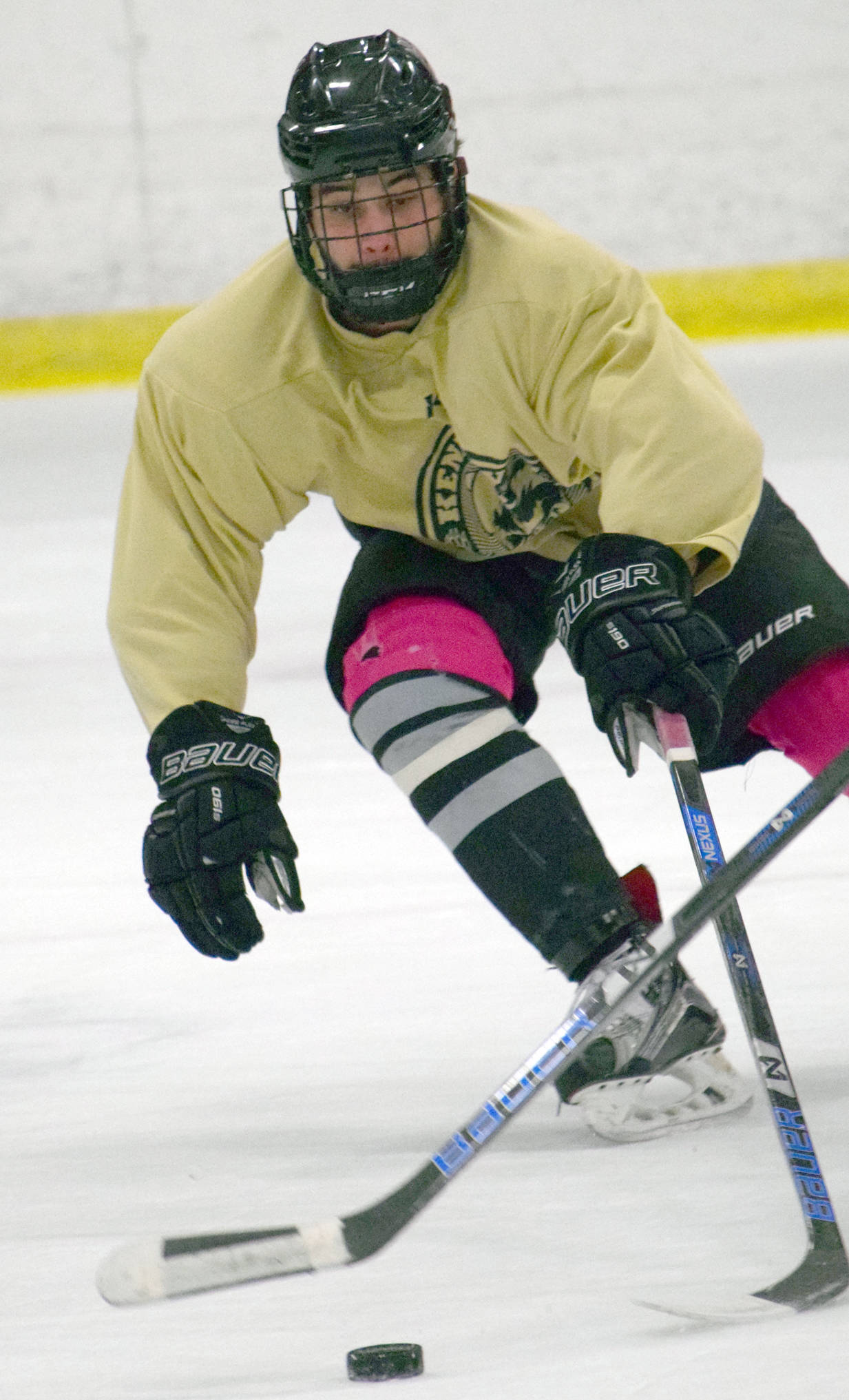 Kenai River Brown Bears defenseman Connor Scahill knocks away the puck during practice Tuesday, Oct. 24, 2017, at the Soldotna Regional Sports Complex. (Photo by Jeff Helminiak/Peninsula Clarion)