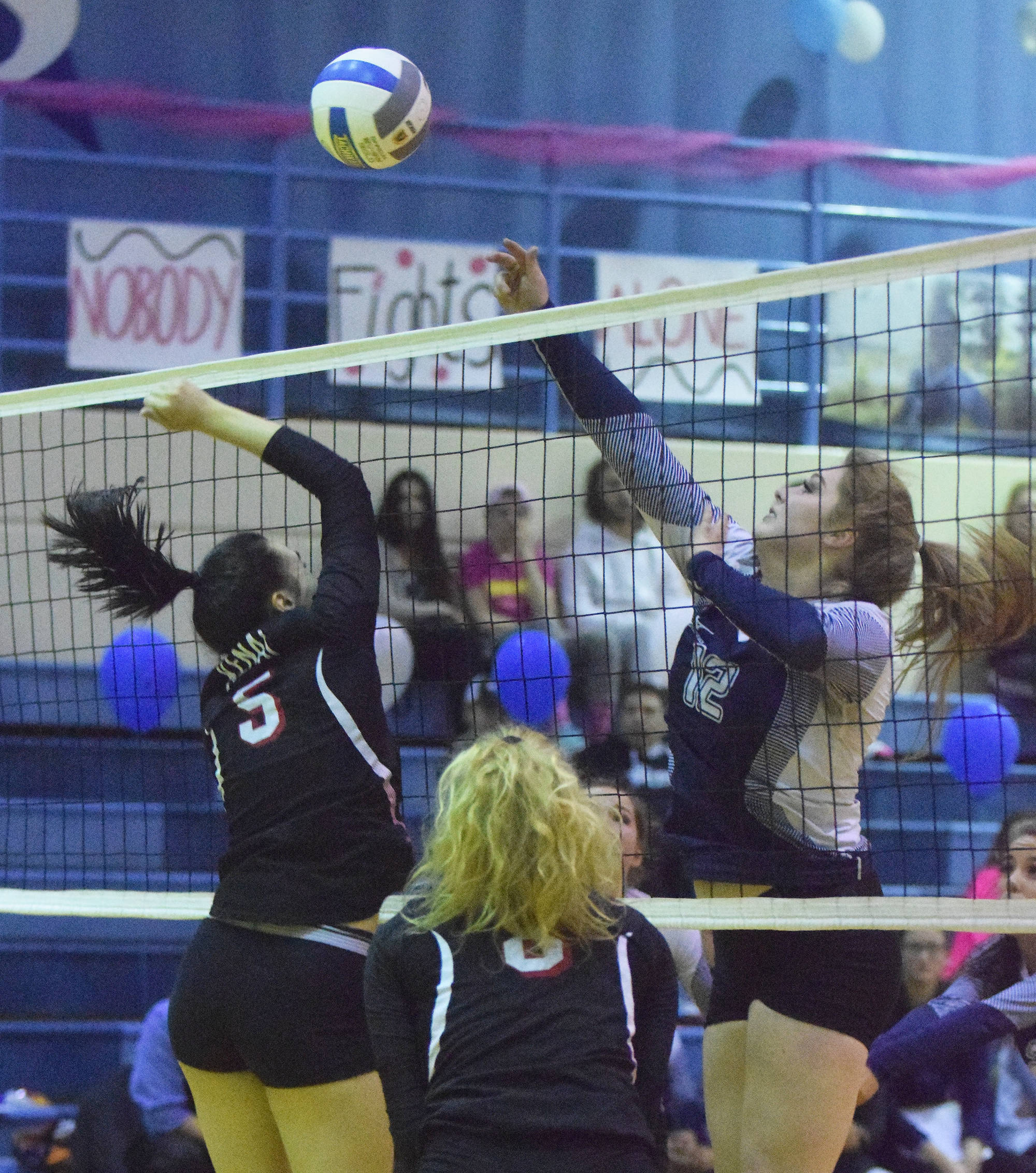 Soldotna sophomore Bailey Leach (12) battles for the ball against Kenai Central’s Nikki Prior Friday night at Soldotna High School. (Photo by Joey Klecka/Peninsula Clarion)