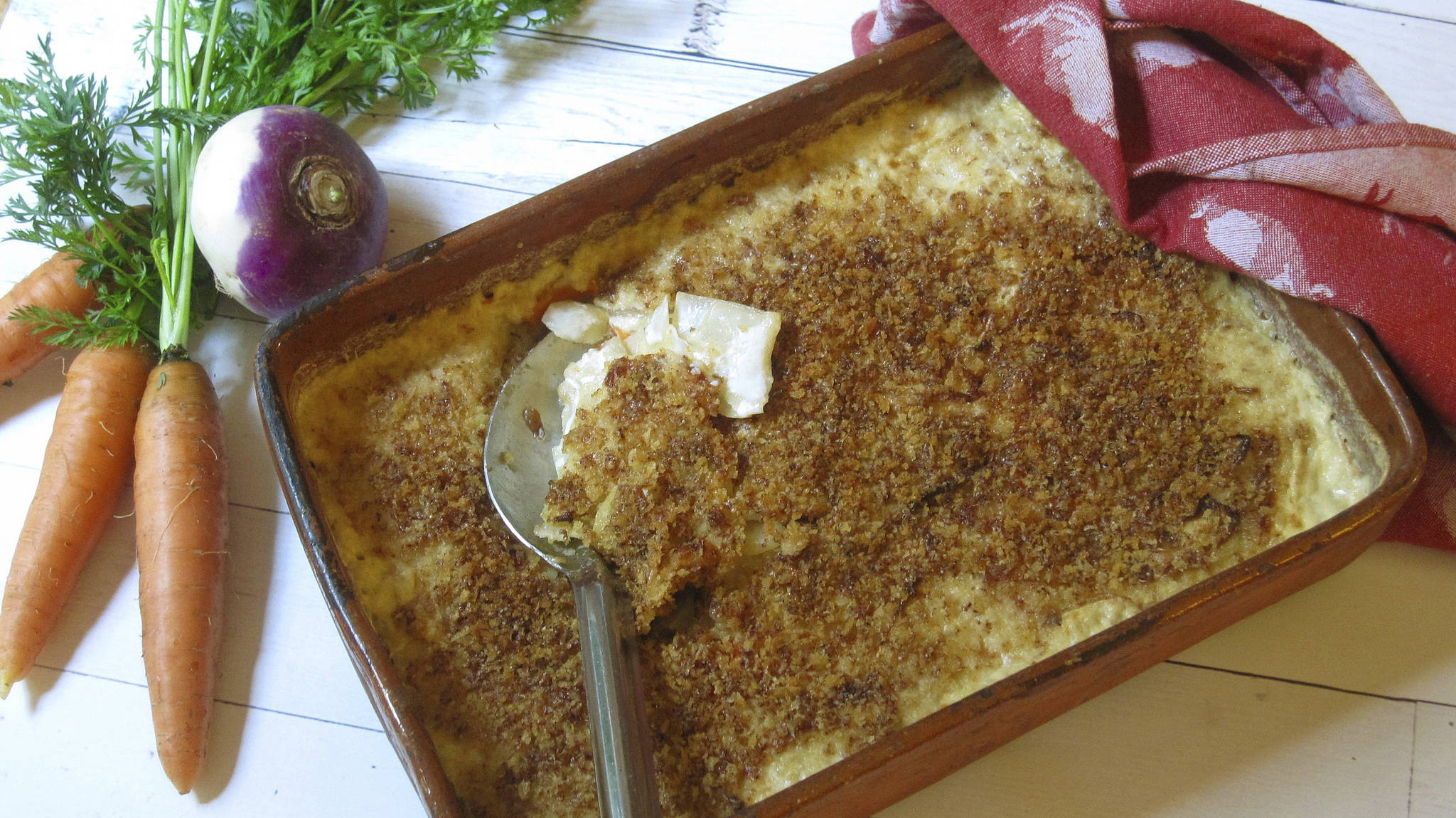 This Oct. 19 photo shows a root vegetable gratin made with turnips, carrots and parsnips. This dish is from a recipe by Sara Moulton. (Sara Moulton via AP)