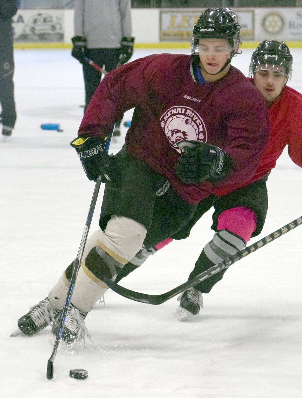 Kenai River Brown Bears defenseman Markuss Komuls shields the puck in a practice at the Soldotna Regional Sports Complex on Wednesday, Nov. 1, 2017. (Photo by Jeff Helminiak/Peninsula Clarion)