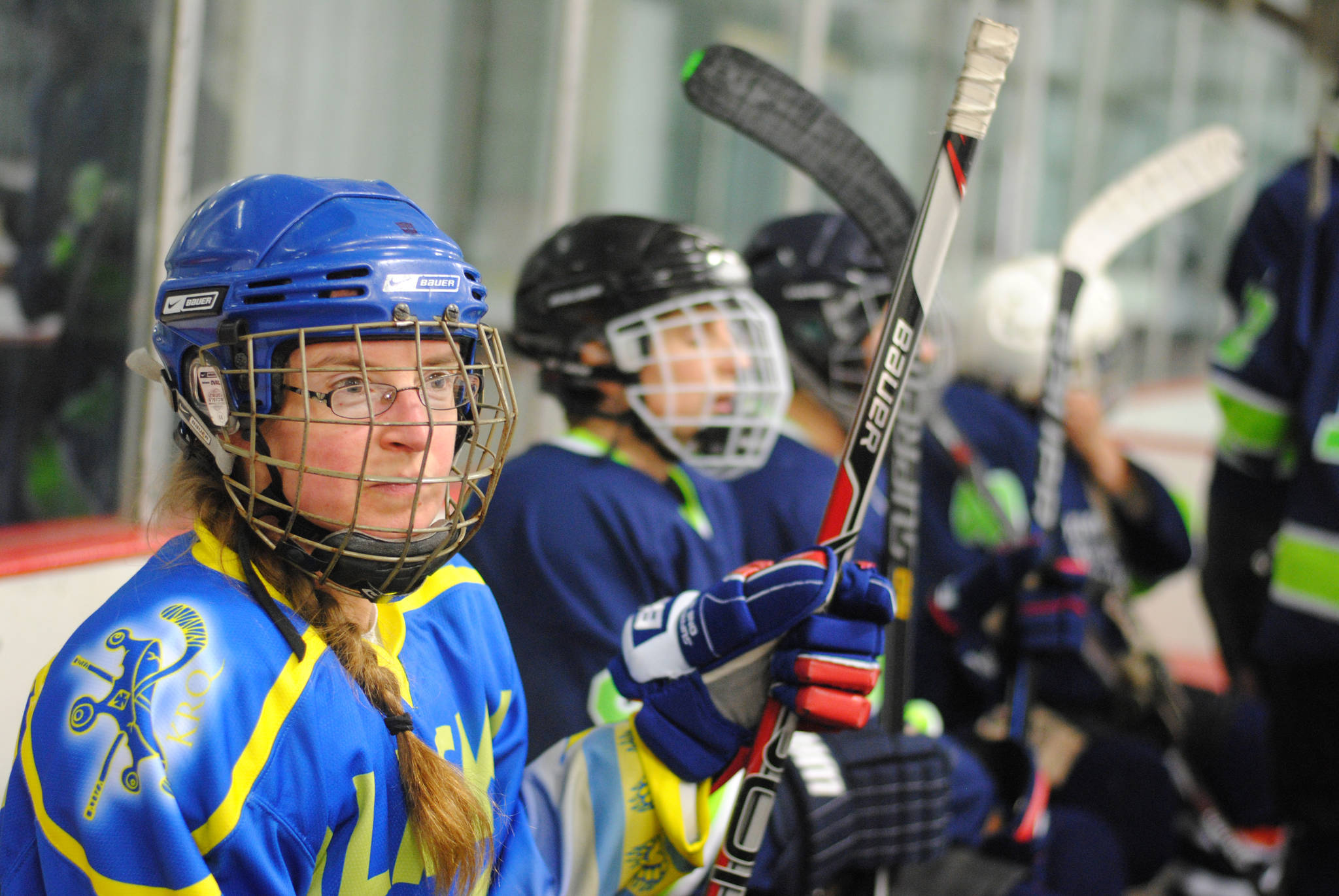 Members of the Kenai River Queens watch their game and wait on a line shift on Thursday, Oct. 26, 2017 at Kenai Multipurpose Facility in Kenai, Alaska. (Photo by Kat Sorensen/Peninsula Clarion)