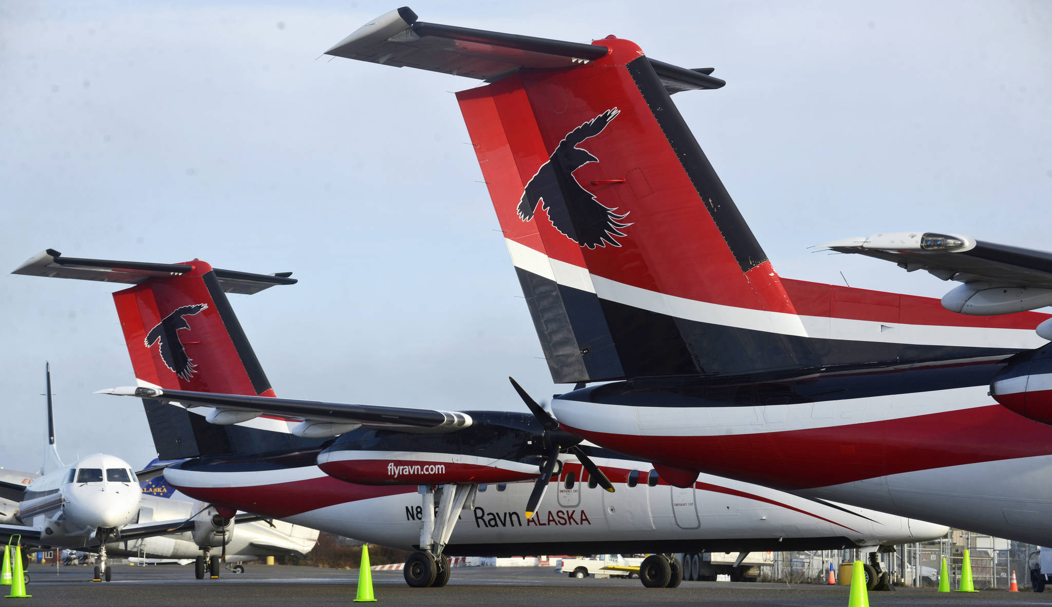 Aircraft diverted by fog from flights to Anchorage or Kodiak — including a trio of Ravn Alaska DeHaviland Dash Eights, two of which are pictured here — sit in front of the Kenai Municipal Airport terminal on Thursday, Nov. 2, 2017 in Kenai, Alaska. Fog throughout the Cook Inlet region has been hampering flight schedules all week — on Monday and Tuesday it grounded planes at the Kenai airport; shifting northward later in the week, it has prevented landings in Anchorage. (Ben Boettger/Peninsula Clarion)