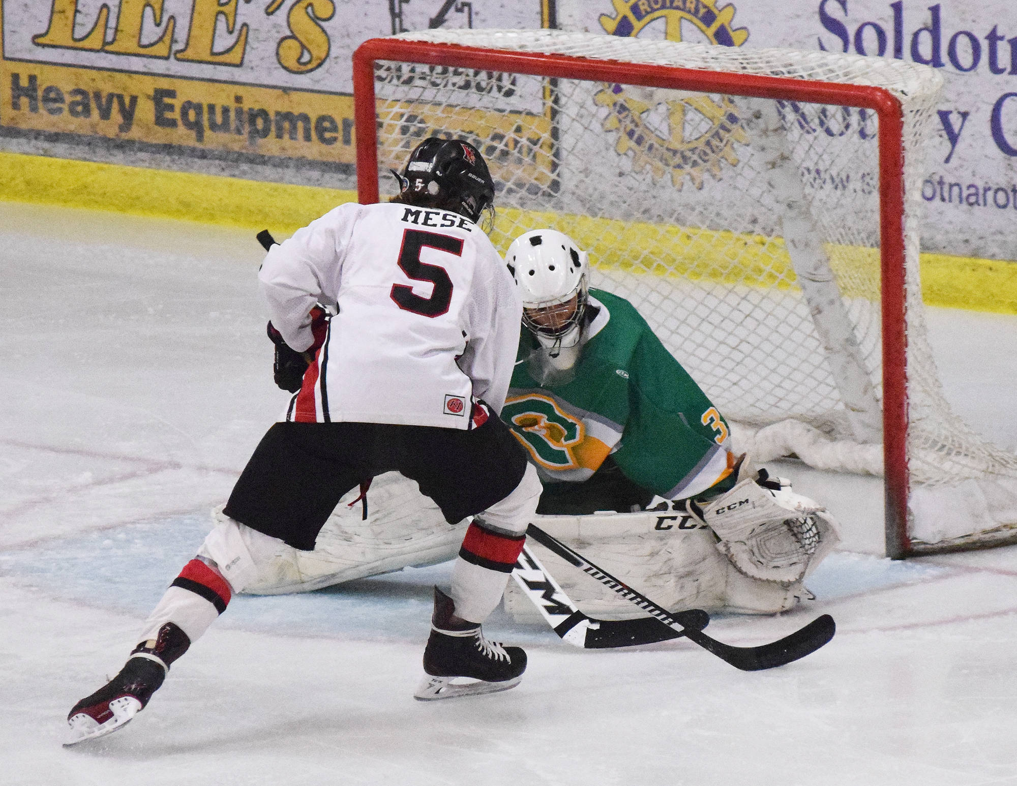 Service goaltender Jordan Watson blocks a shot from Kenai Central’s Levi Mese (5) Thursday at the Peninsula Ice Challenge at the Soldotna Regional Sports Complex. (Photo by Joey Klecka/Peninsula Clarion)