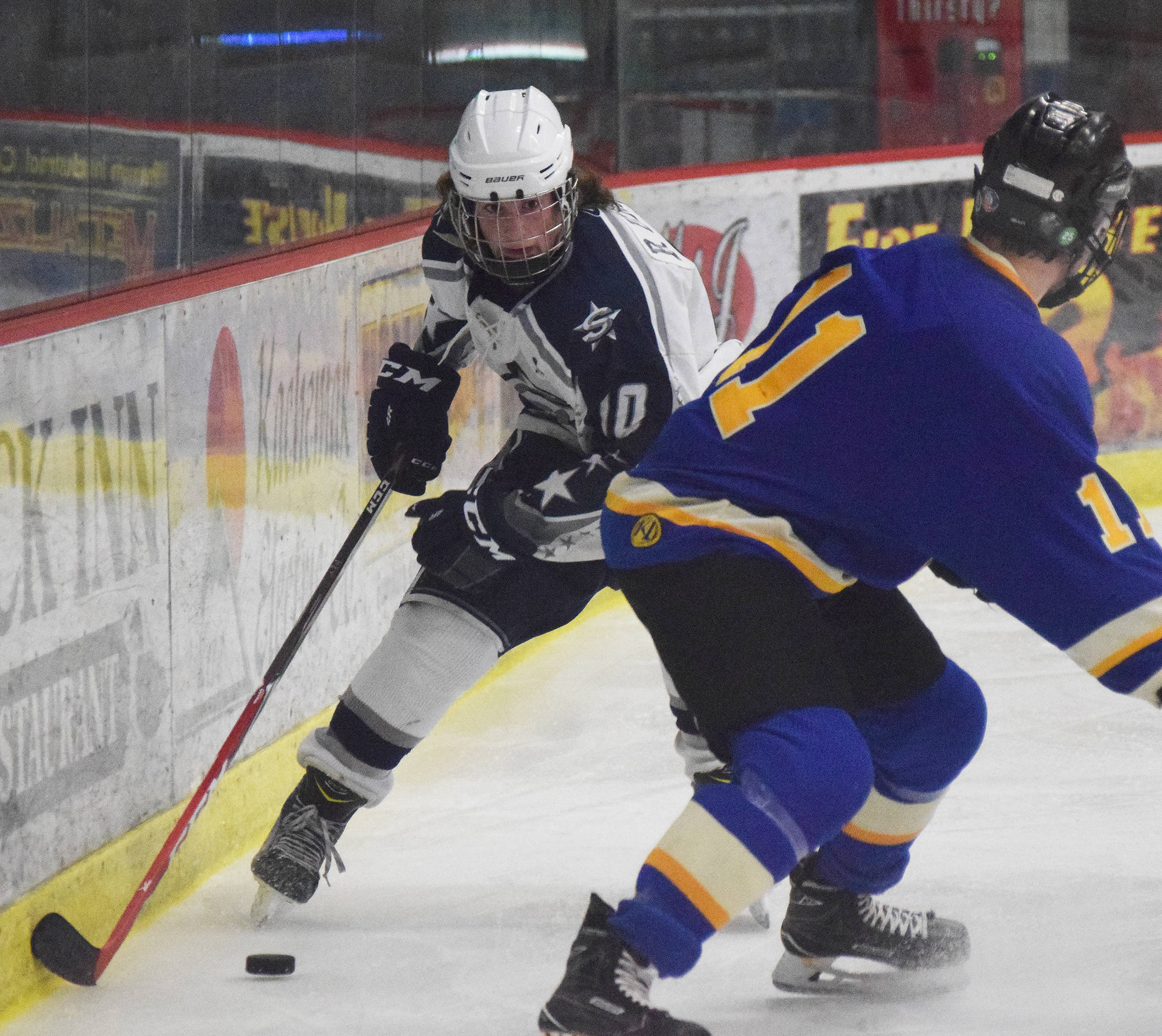 Soldotna’s Braxton Urban (10) slips the puck by Monroe Catholic’s Riley Ott Thursday at the Peninsula Ice Challenge at the Soldotna Regional Sports Complex. (Photo by Joey Klecka/Peninsula Clarion)