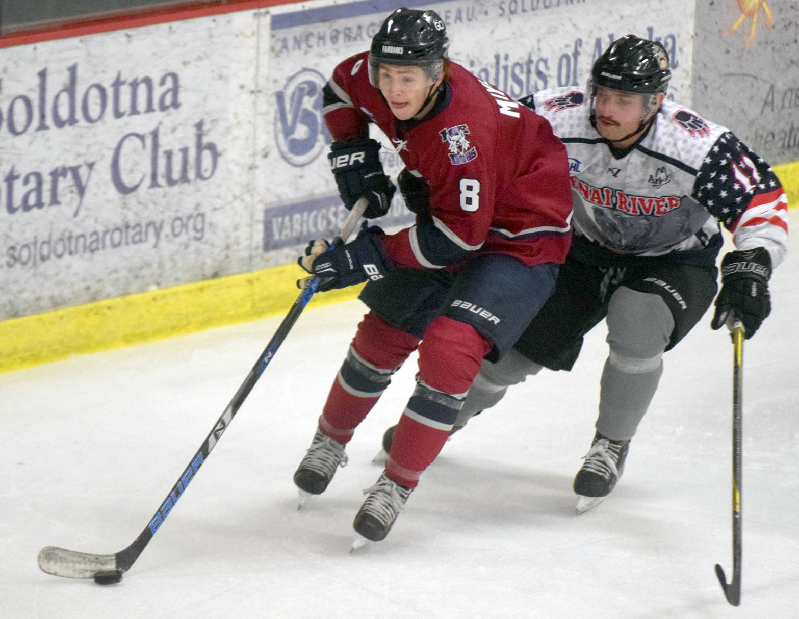 Fairbanks Ice Dogs defenseman Kyle Mayhew protects the puck from Kenai River Brown Bears forward Gil Garcia on Friday, Nov. 3, 2017, at the Soldotna Regional Sports Complex. (Photo by Jeff Helminiak/Peninsula Clarion)