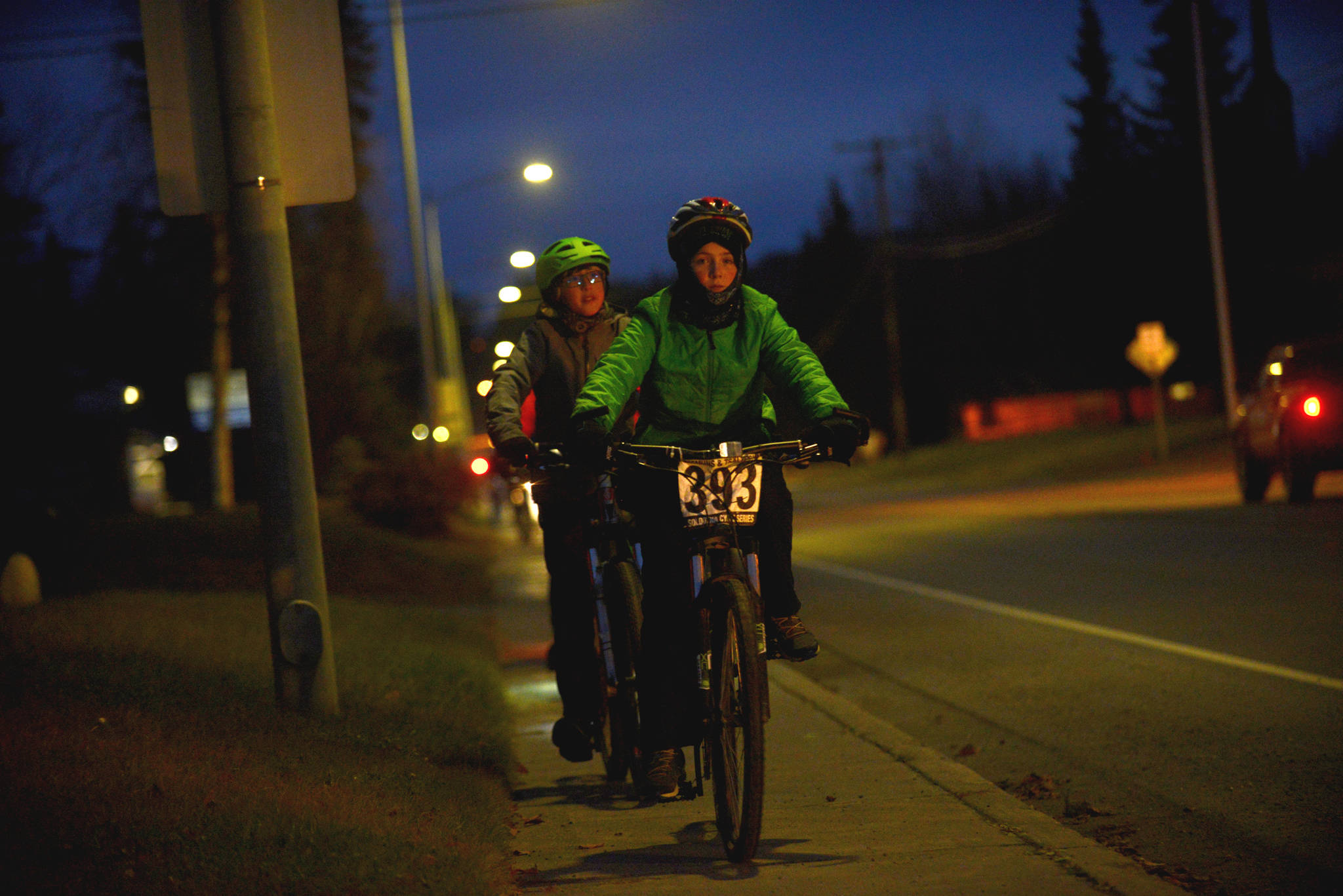 Above: :Bicyclists rode through the streets of Soldotna on Saturday night for the first full moon bike ride, a social event that brings participants on a slow, but steady, bike ride throughout the city’s streets to coincide with the full moon.  Top: Bicyclists of all ages joined in on the first full moon bike ride, a social ride through the streets of Soldotna on Saturday night. (Photos by Ben Boettger/Peninsula Clarion)