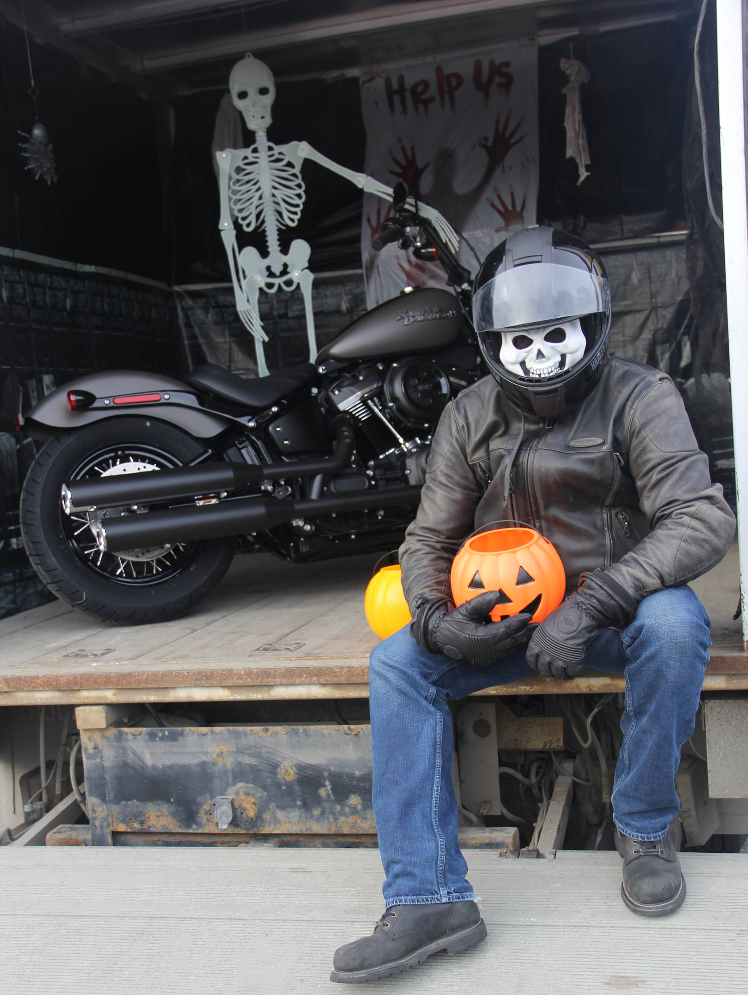 Biker Si of Peninsula Harley hands out sweets at Boys & Girls Club Trunk or Treat.