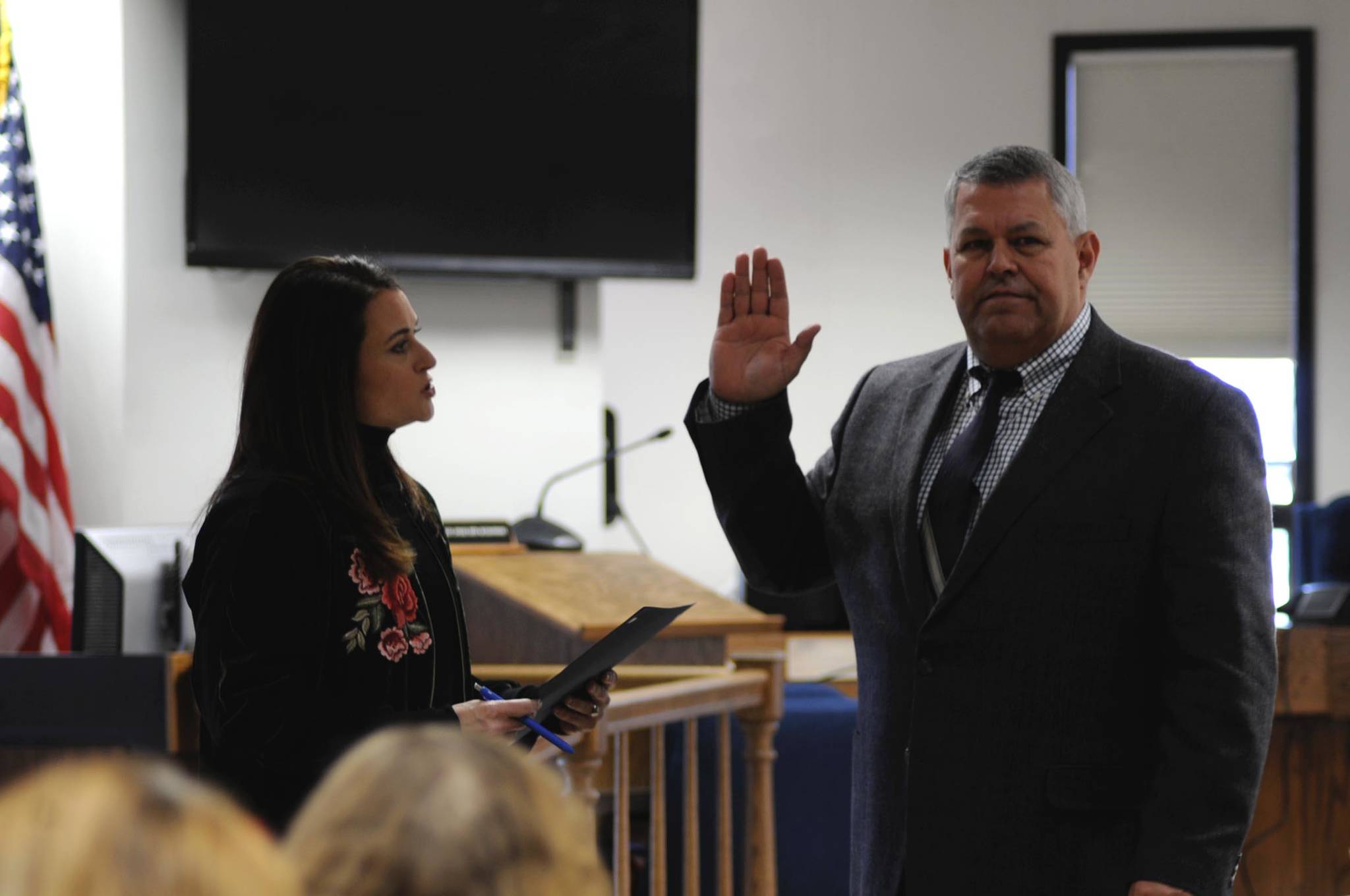 Borough Clerk Johni Blankenship (left) administers the oath of office to Borough Mayor Charlie Pierce during a swearing-in ceremony at the George A. Navarre Borough Administration Building on Monday, Nov. 6, 2017 in Soldotna, Alaska. Pierce won the mayor’s seat in a runoff election held Oct. 24, narrowly defeating opponent Linda Hutchings with a margin of 45 votes. (Photo by Elizabeth Earl/Peninsula Clarion)