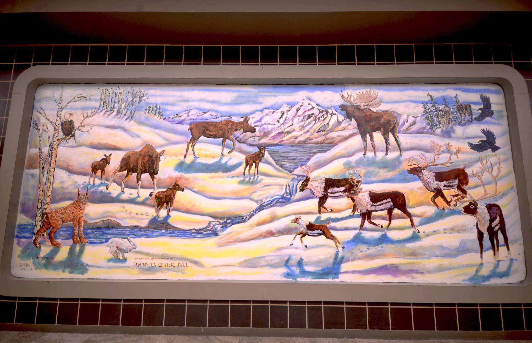 This Tuesday, Nov. 7, 2017 photograph shows the mural that artist Suzie Shrivener finished painting Saturday over a store-front window at the Peninsula Center Mall in Soldotna, Alaska. Shrivener, who began painting about two years ago after an injury, did the latex paint and airbrushed mural — her first — after setting up a display of her work in the mall’s nearby showcase. She offered the mural to the mall for free to get experience in window painting. “Painting’s relatively new to me, so to work on something that big, I didn’t know how it would turn out,” Shrivener said. “I didn’t know what would happen, but I thought it was a good opportunity.” (Photo by Ben Boettger/Peninsula Clarion)