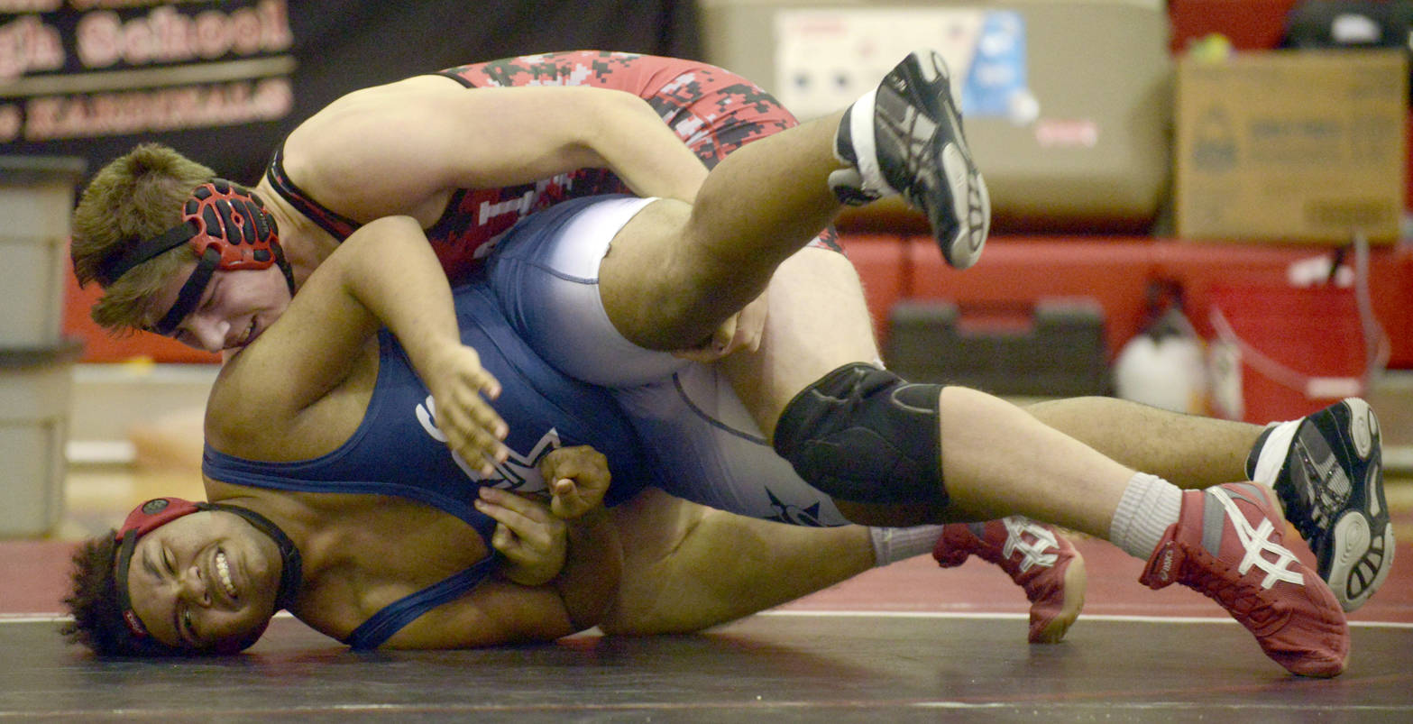 Kenai Central’s Byron Dunham controls Soldotna’s Eli Floyd at 195 pounds en route to a pin Thursday, Nov. 9, 2017, at Kenai Central High School. (Photo by Jeff Helminiak/Peninsula Clarion)