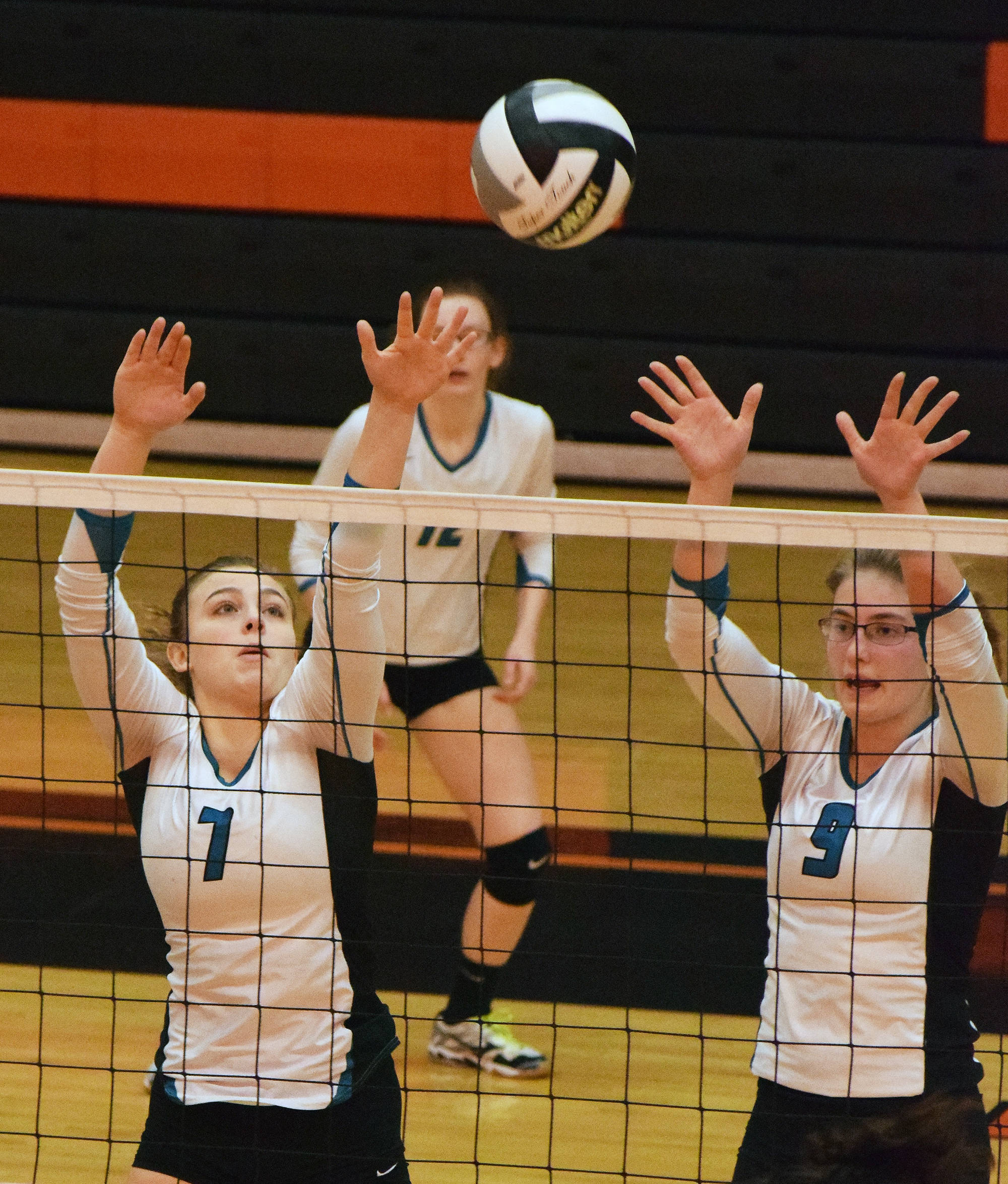 Nikiski junior Bethany Carstens (7) teams up with senior Jamie Yerkes to put up a block Friday against Barrow at the Class 3A state volleyball tournament at West High School. (Photo by Joey Klecka/Peninsula Clarion)