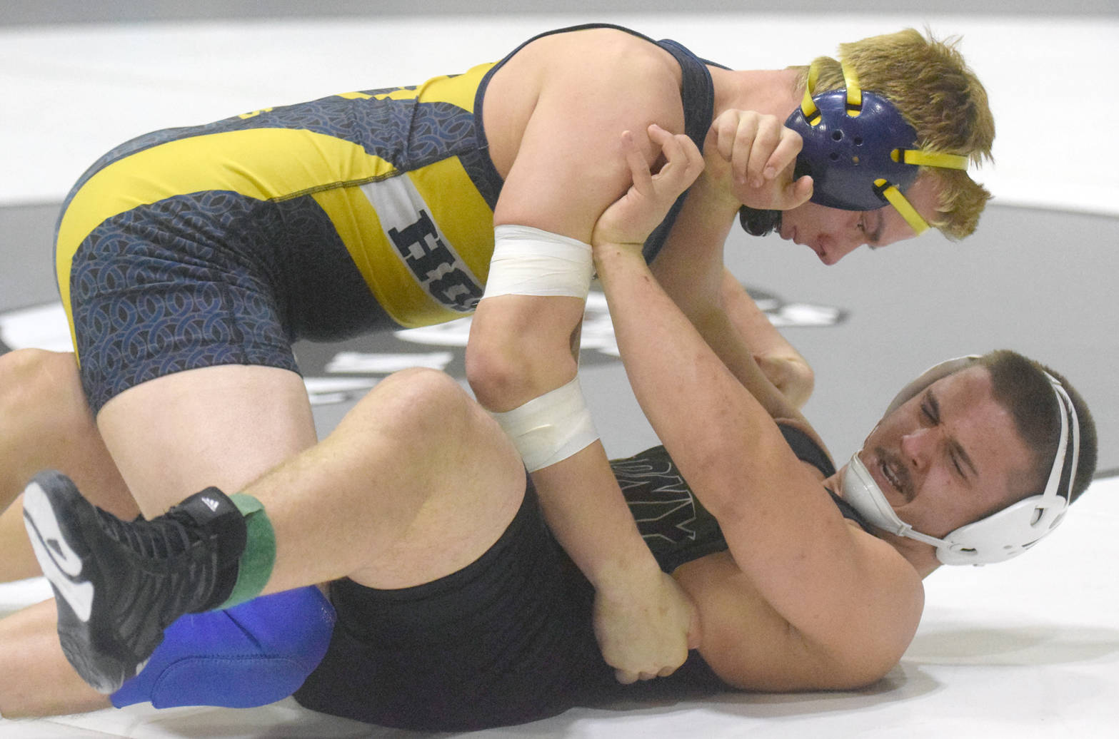 Homer’s Levi King works his way to a pin of Colony’s Simon Ganchenko at 195 pounds Saturday, Nov. 11, 2017, in the championship dual of the Peninsula Duals at Nikiski High School. (Photo by Jeff Helminiak/Peninsula Clarion)