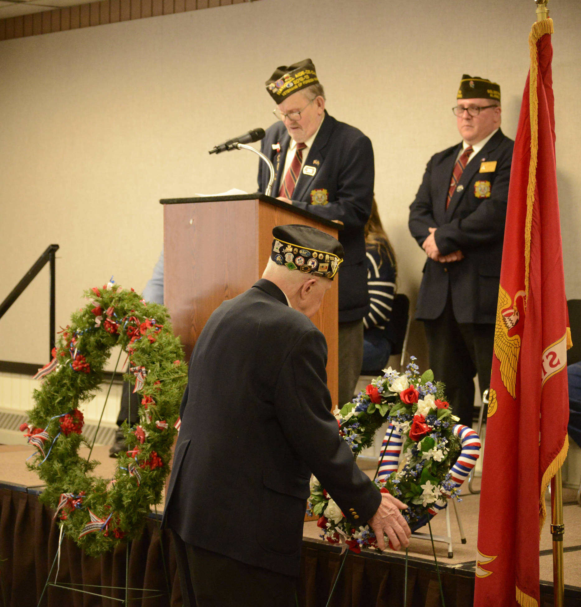 Herb Stettler reads the poem “In Flanders Fields” as wreaths are laid during a Veterans Day ceremony Saturday at the Soldotna Regional Sports Complex. (Photo by Dan Balmer/For the Clarion)