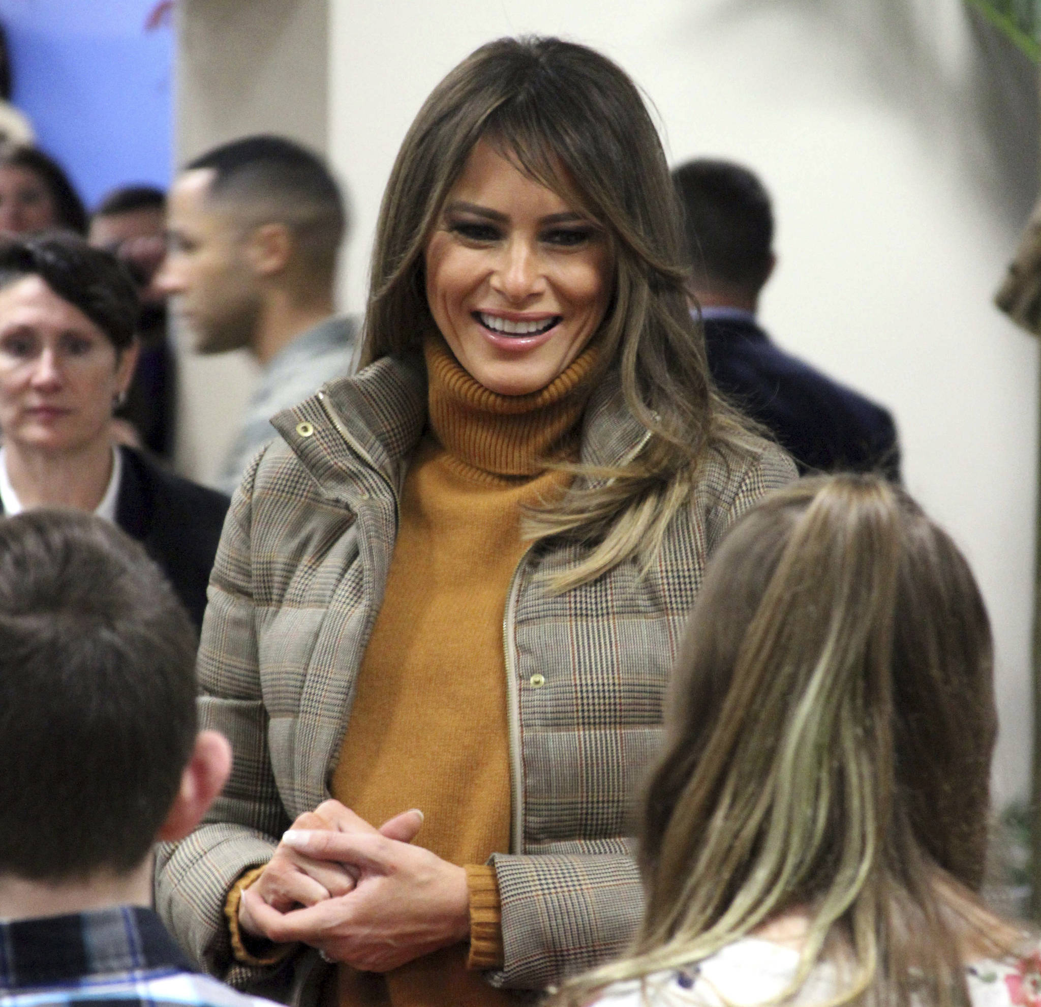 First lady Melania Trump listens as children tell her about 3D printing at Joint Base Elmendorf-Richardson, Alaska, on Friday, Nov. 10, 2017. Trump visited with children taking part in programs for the children of military members at the base in Anchorage, Alaska, before flying back to Washington, D.C. (AP Photo/Mark Thiessen)