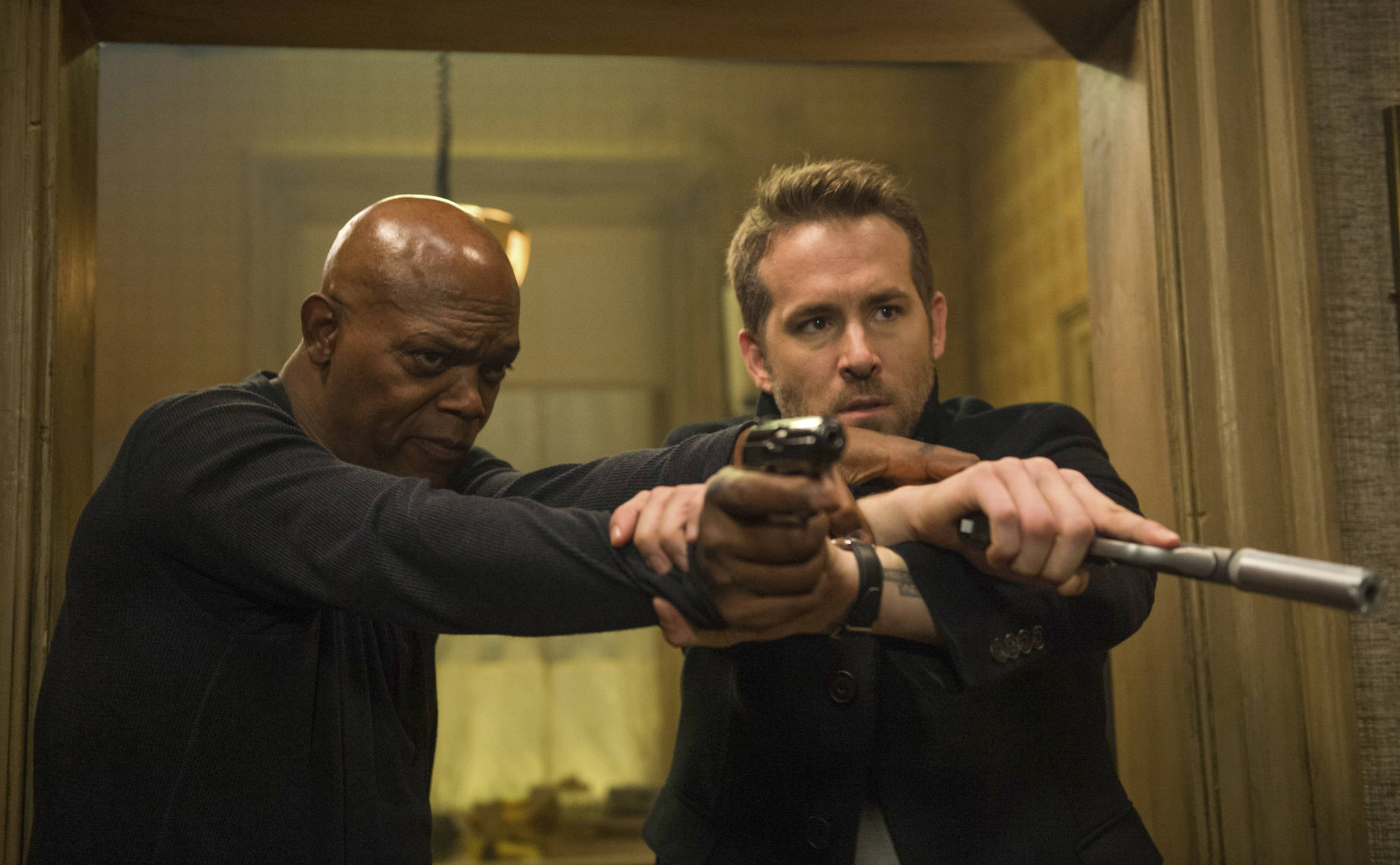 This image released by Lionsgate shows Samuel L. Jackson, left, and Ryan Reynolds in “The Hitman’s Bodyguard.” (Jack English/Lionsgate via AP)