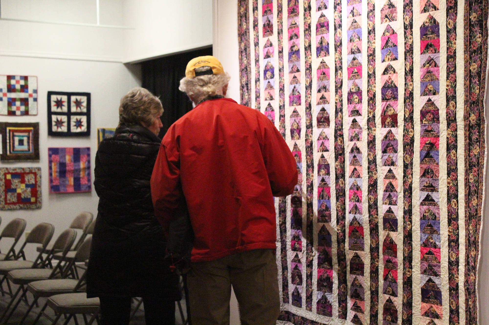Passersby inspect the work of the Kachemak Bay Quilters during a First Friday exhibit Nov. 3 at the Homer Council on the Arts in Homer. The quilting group has been around for more than 30 years. (Photo by Megan Pacer/Homer News)