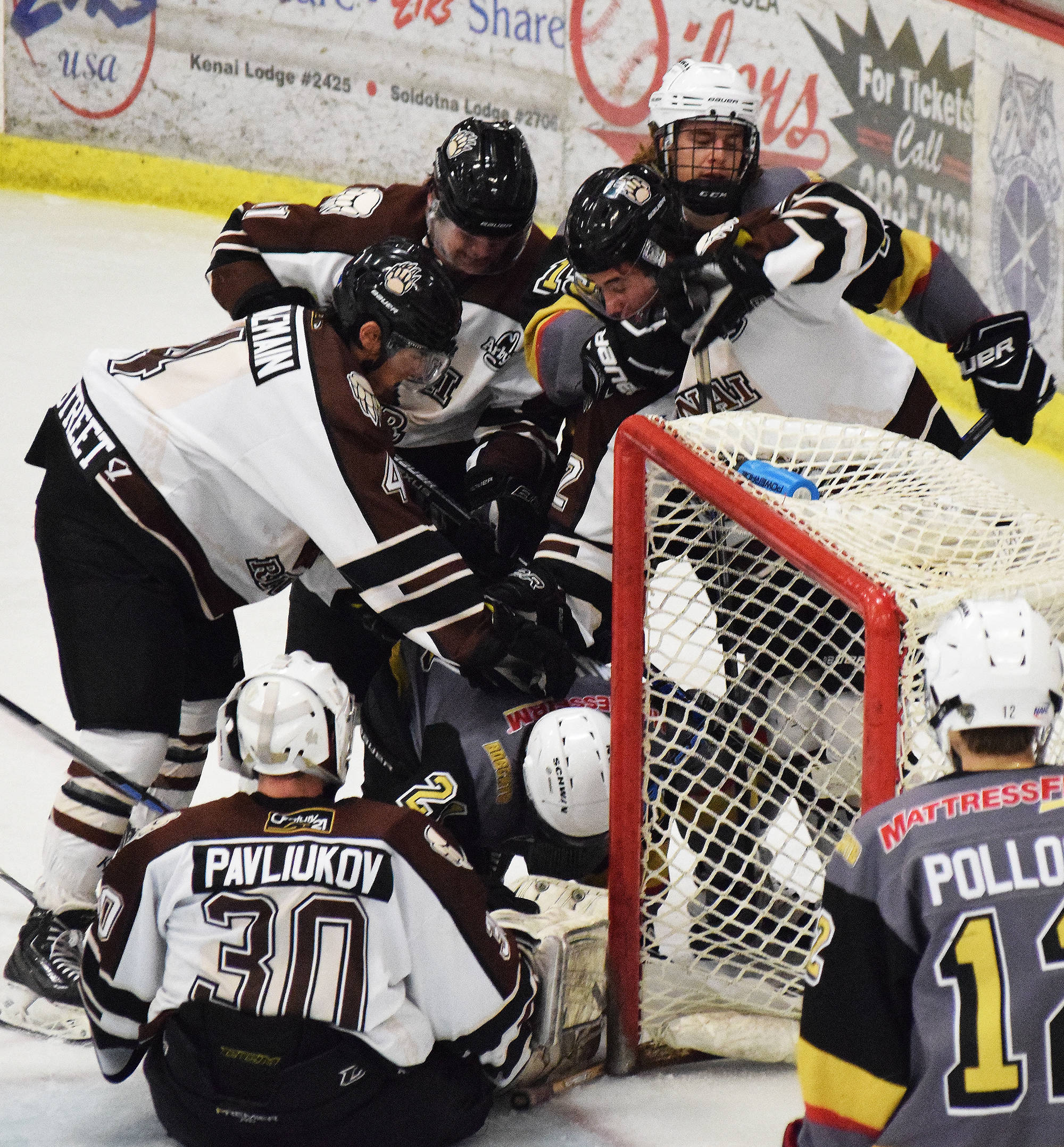 A scrum of Kenai River and Bismarck players gather around the Brown Bears net Friday night at the Soldotna Regional Sports Complex. (Photo by Joey Klecka/Peninsula Clarion)