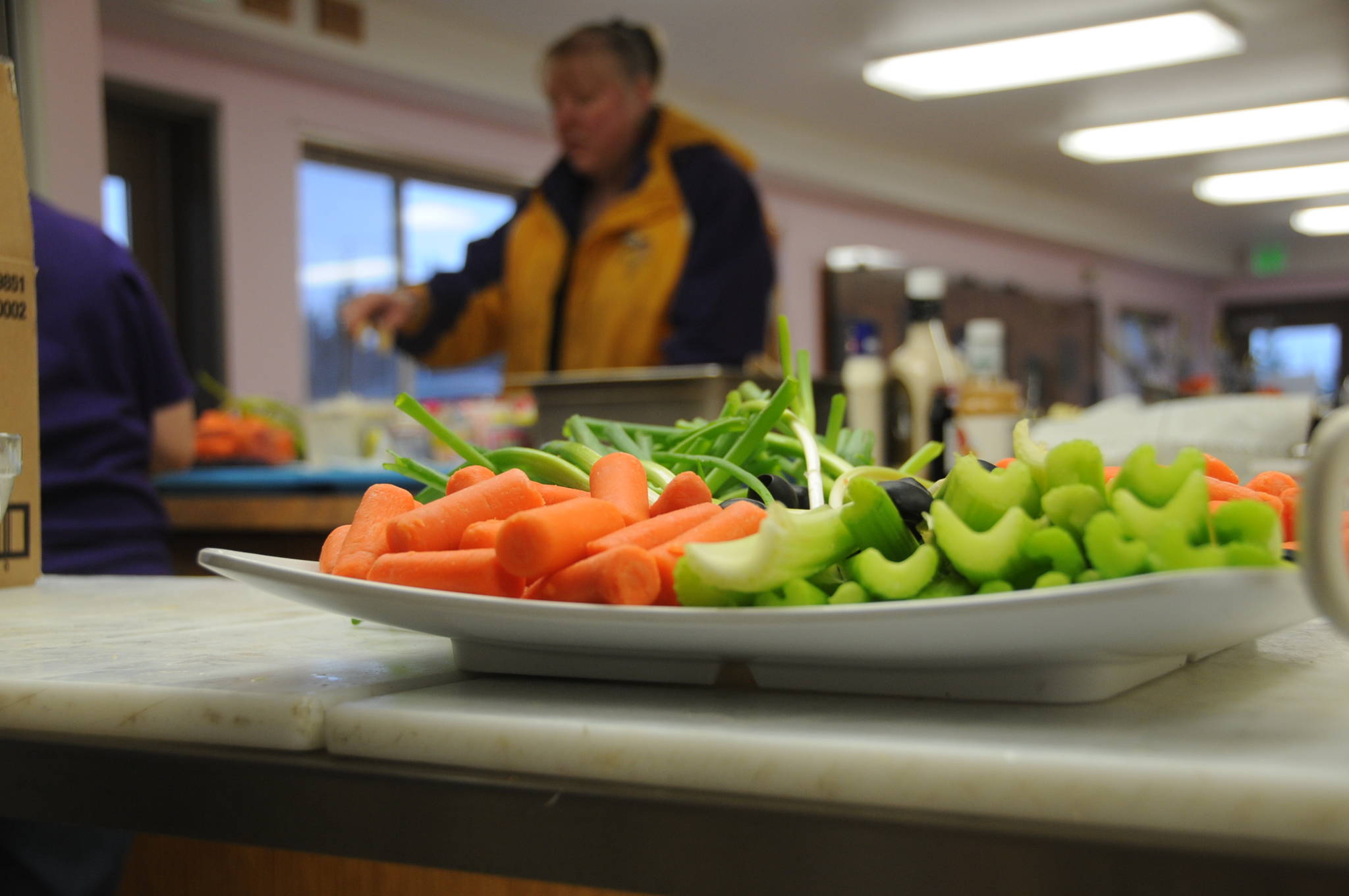 In this November 2015 photo, a diner gathers a plate of food for the Thanksgiving meal at the Kenai Peninsula Food Bank’s Fireweed Diner near Soldotna, Alaska. (Photo by Elizabeth Earl/Peninsula Clarion, file)