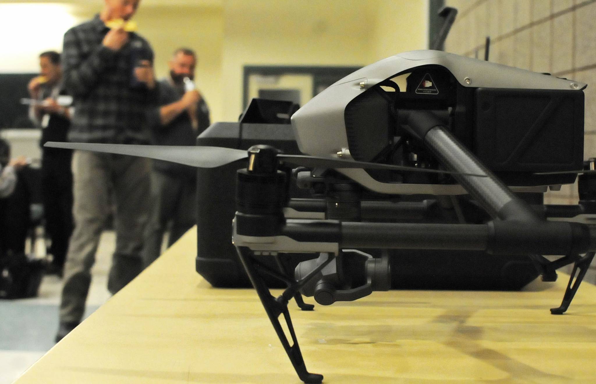 Attendees at the Kenai Peninsula Borough’s drone technical conference check out drones on a side table at the Challenger Learning Center on Tuesday in Kenai (Photo by Elizabeth Earl/Peninsula Clarion)