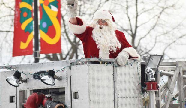 Santa greets a crowd of excited families as he cruises into the Kenai Chamber of Commerce and Visitor Center parking lot on a Kenai Fire Department engine Nov. 25, 2016 in Kenai. (Clarion file photo)