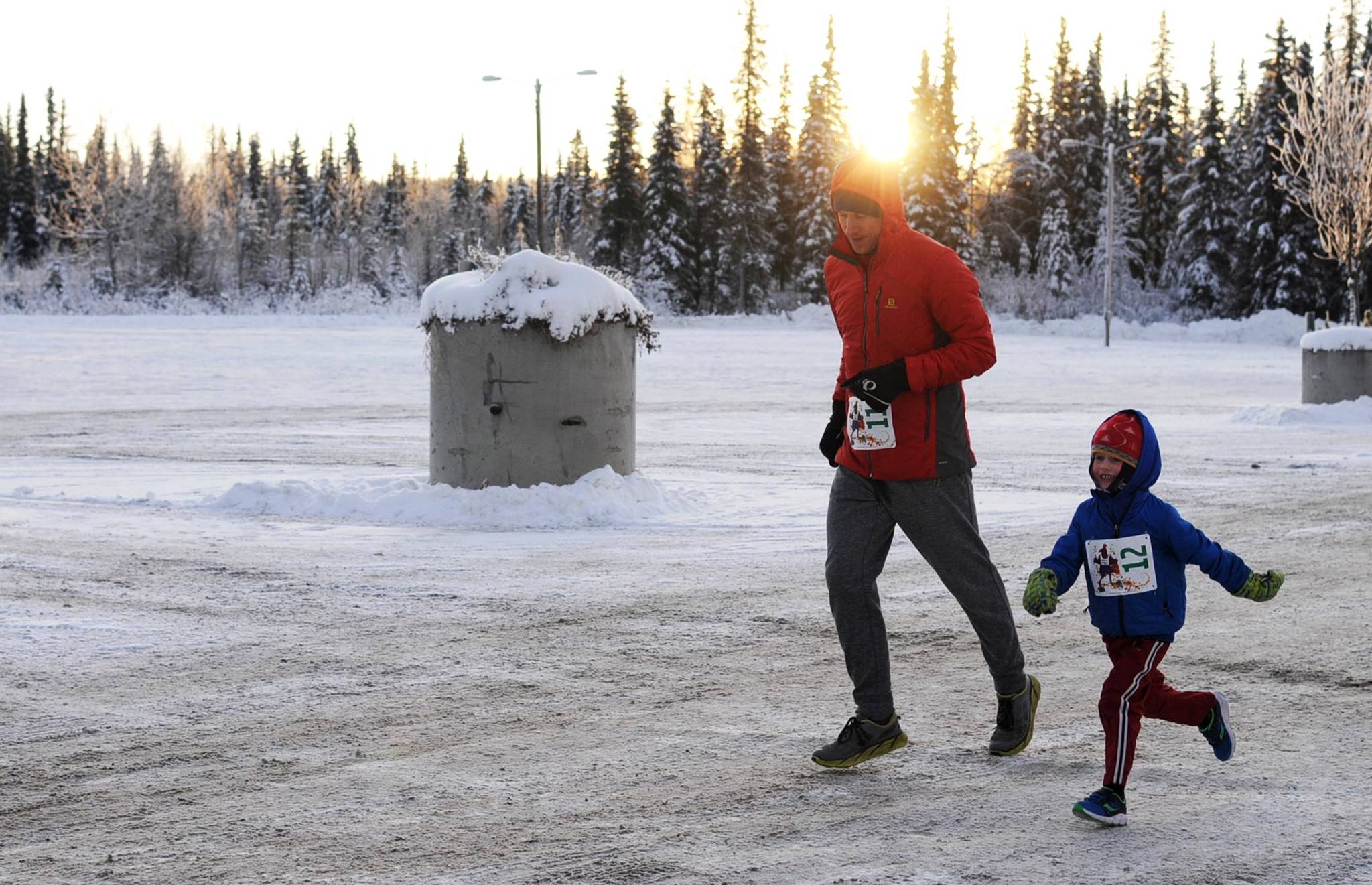 Adam Reimer and his son Gus Reimer, 4, finish the 1-mile Turkey Trot race at the Soldotna Regional Sports Complex on Thursday, Nov. 23, 2017 in Soldotna, Alaska. The organizers of the event, which also included a 5K race, donated all the proceeds to Freedom House, a Soldotna nonprofit sober living home for women recovering from addiction. (Photo by Elizabeth Earl/Peninsula Clarion)