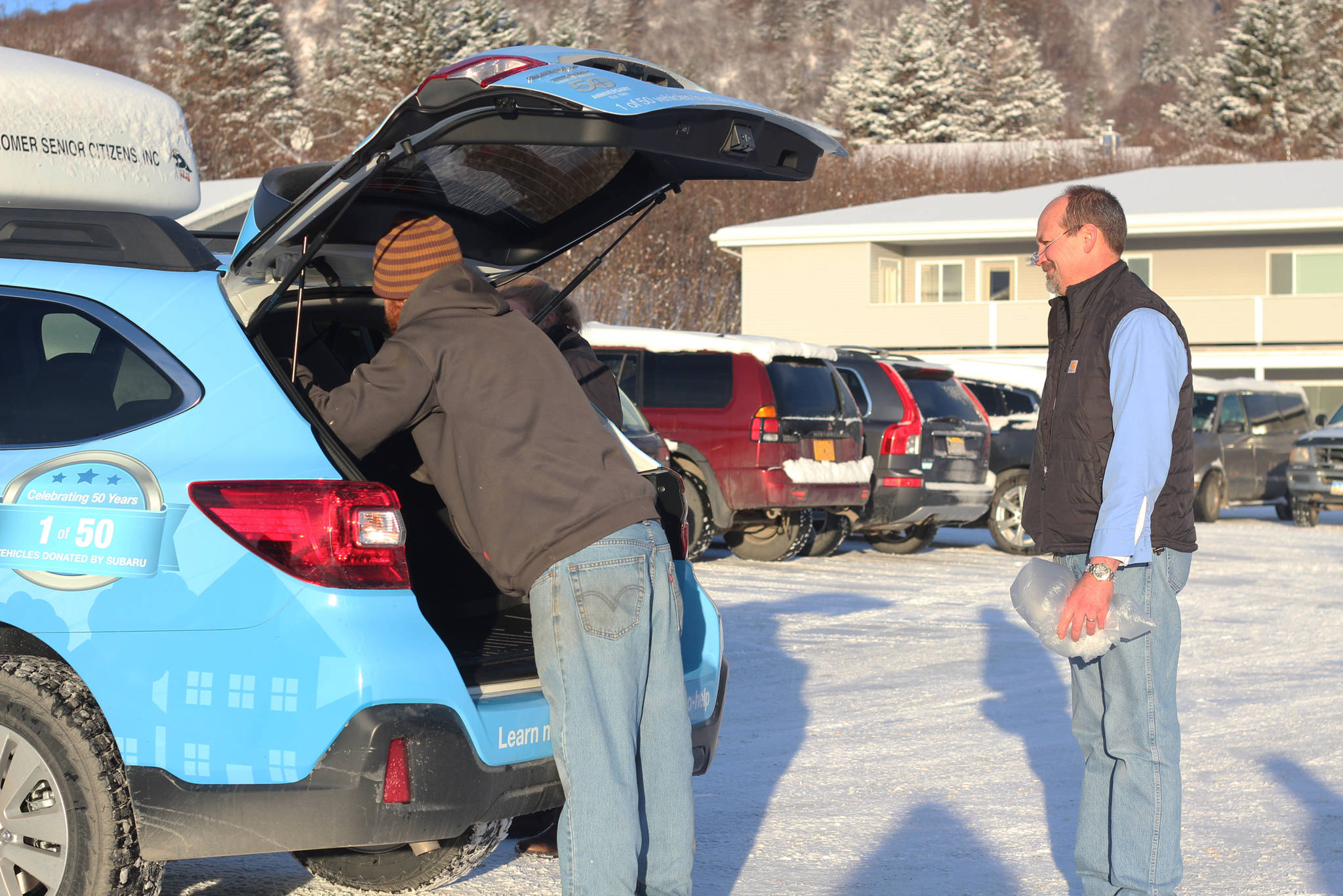 Volunteers pack up the Homer Senior Citizens Center’s new Subaru outback with meals to be delivered through its Meals on Wheels program Monday, Nov. 20, 2017 at the center in Homer, Alaska. The center got the vehicle through a grant specifically to help with meal deliveries. (Photo by Megan Pacer/Homer News)