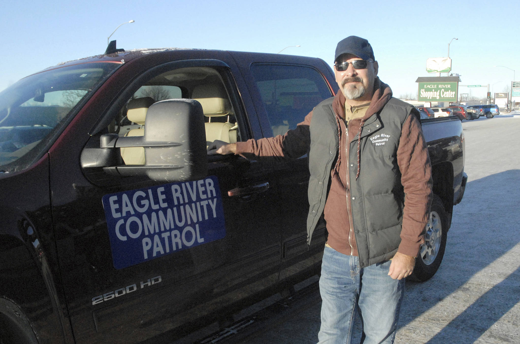 In this Nov. 13, 2017, photo, Cliff Cook stands next to his pick-up truck in downtown Eagle River, Alaska. Cook, who started the Eagle River Community Patrol in early November, 2017, said the patrol is needed due to a recent increase in crime in the area. (Matt Tunseth/Chugiak-Eagle River Star via AP)
