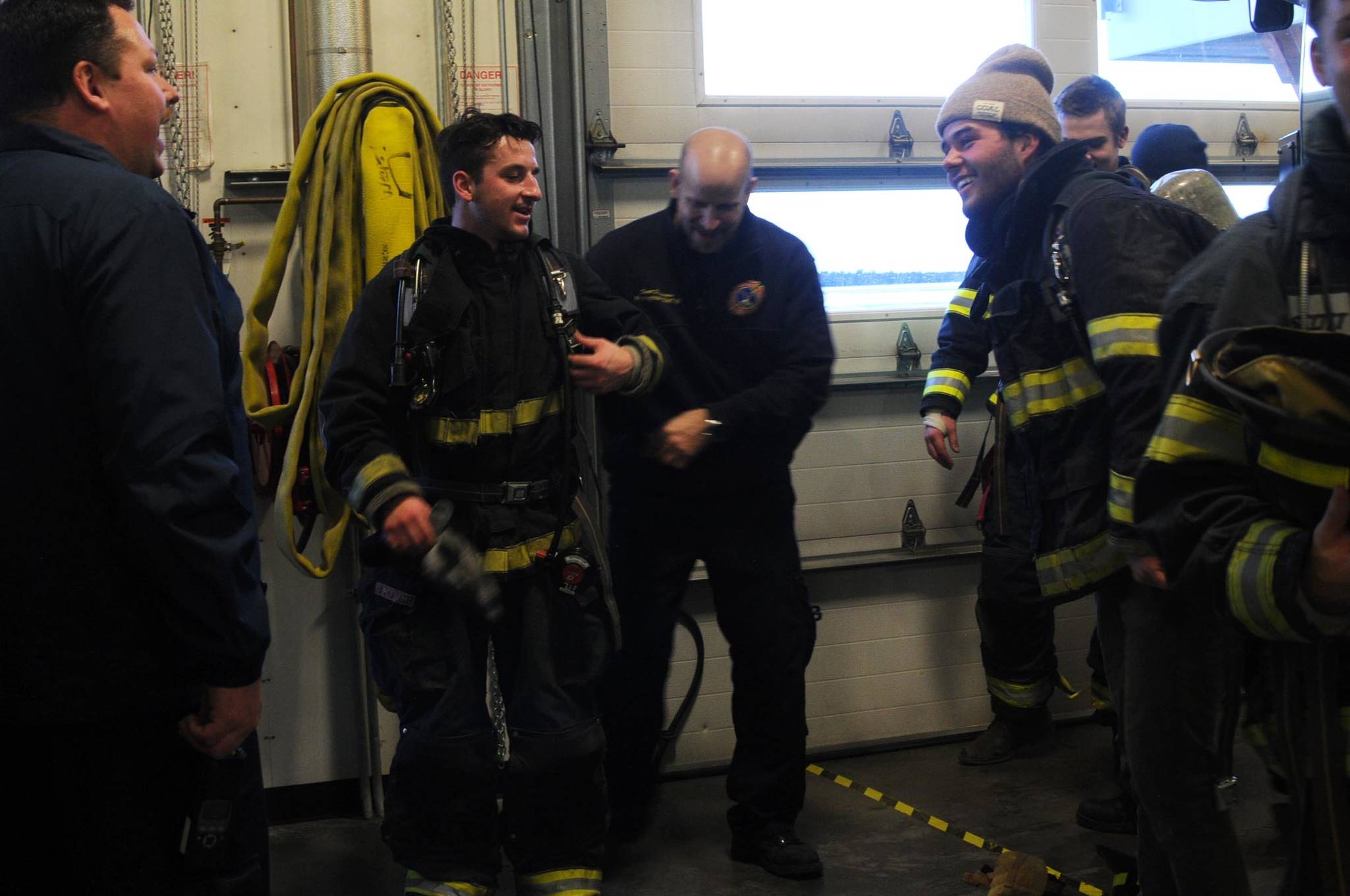 Kenai Fire Marshal Tommy Carver talks to the Kenai River Brown Bears hockey team players during a tour and training demonstratoin at the Kenai Emergency Operations Center on the Kenai Municipal Airport on Tuesday, Nov. 28, 2017 in Kenai, Alaska. Kenai Fire Department firefighters walked the Brown Bears players through some of the training and tools firefighters use to give them an idea of what a career in fire response is like. (Photo by Elizabeth Earl/Peninsula Clarion)