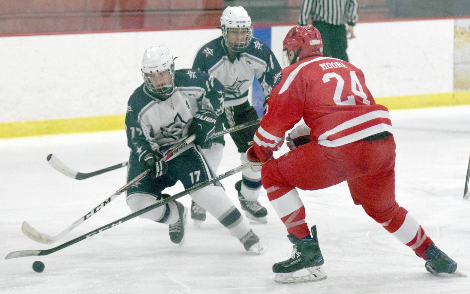 Soldotna’s Wyatt Medcoff attacks Wasilla’s Wyatt Moore while Soldotna’s Alex Montague supports the puck Friday, Dec. 1, 2017, at the Soldotna Regional Sports Complex. (Photo by Jeff Helminiak/Peninsula Clarion)
