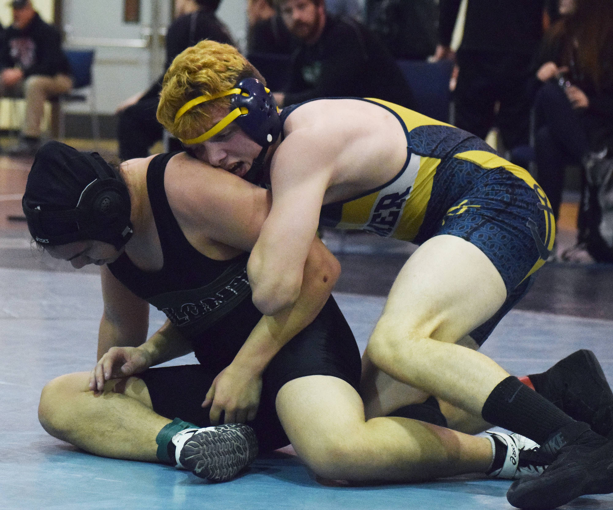 Homer’s Chris Cudaback (right) wrestles with Frank Urbano of Colony in a 170-pound battle at the North-South tournament Saturday at Soldotna Prep School. (Photo by Joey Klecka/Peninsula Clarion)