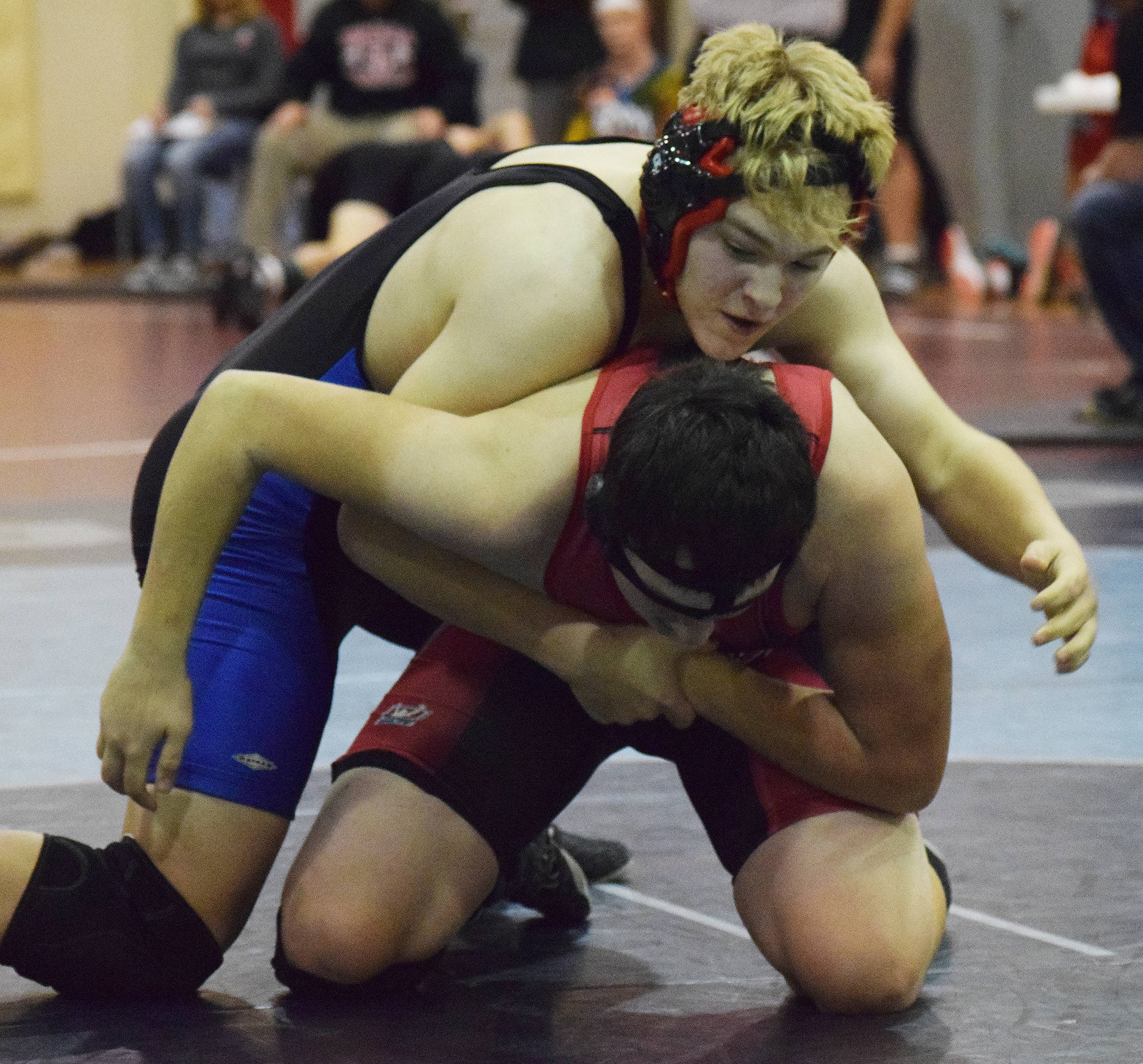 Soldotna’s Max Rogers attempts to pin Kenai Central’s Rocky Sherbahn in a 182-pound match Saturday at the North-South tournament at Soldotna Prep School. (Photo by Joey Klecka/Peninsula Clarion)