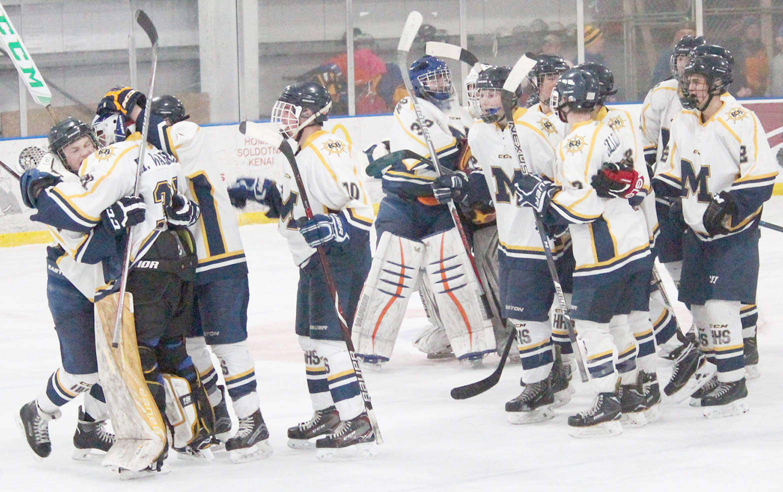 Homer High School’s hockey team celebrates its 2-1 win against Colony High School on Friday, Dec. 1, 2017 at Kevin Bell Arena in Homer. (Photo by Megan Pacer/Homer News)