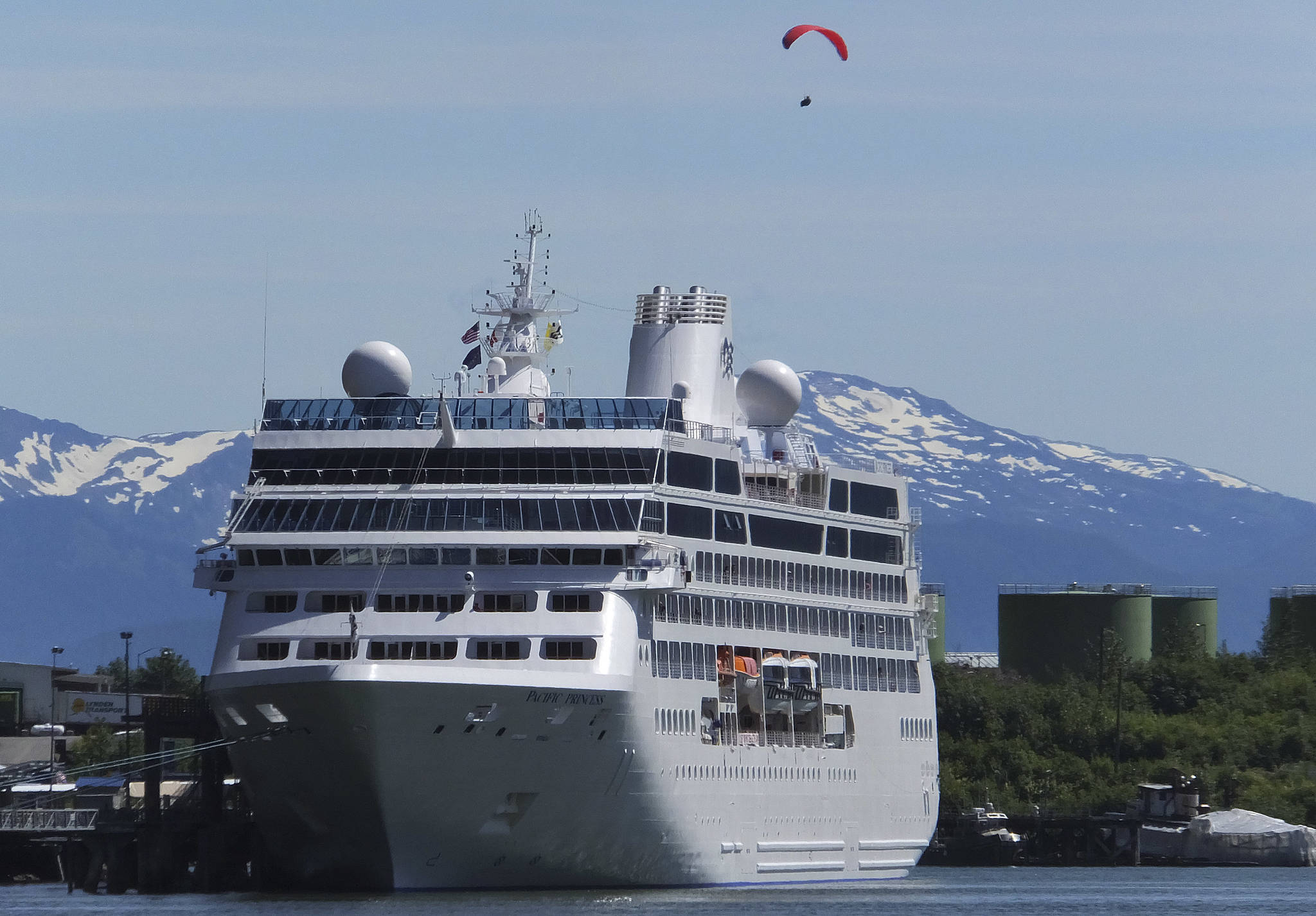 This June 26, 2014, file photo, shows a cruise ship docked in Juneau, while a paraglider soars above. The tax bill approved Saturday by the U.S. Senate will open part of the Arctic National Wildlife Refuge to oil and gas drilling. The measure also struck down a proposed cruise ship tax that Republican Sen. Lisa Murkowski said would have disproportionately affected her state. (AP Photo/Becky Bohrer, File)