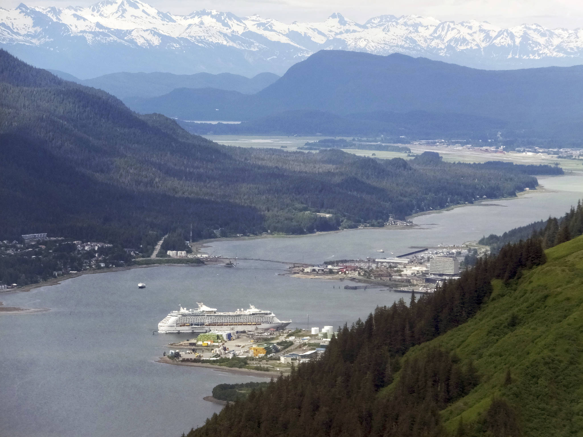 FILE- In this June 4, 2017 file photo, a cruise ship sits docked near downtown Juneau, Alaska. The tax bill approved Saturday, Dec. 2, 2017, by the U.S. Senate will open part of the Arctic National Wildlife Refuge to oil and gas drilling. The measure also struck down a proposed cruise ship tax that Republican Sen. Lisa Murkowski said would have disproportionately affected her state. (AP Photo/Becky Bohrer, File)