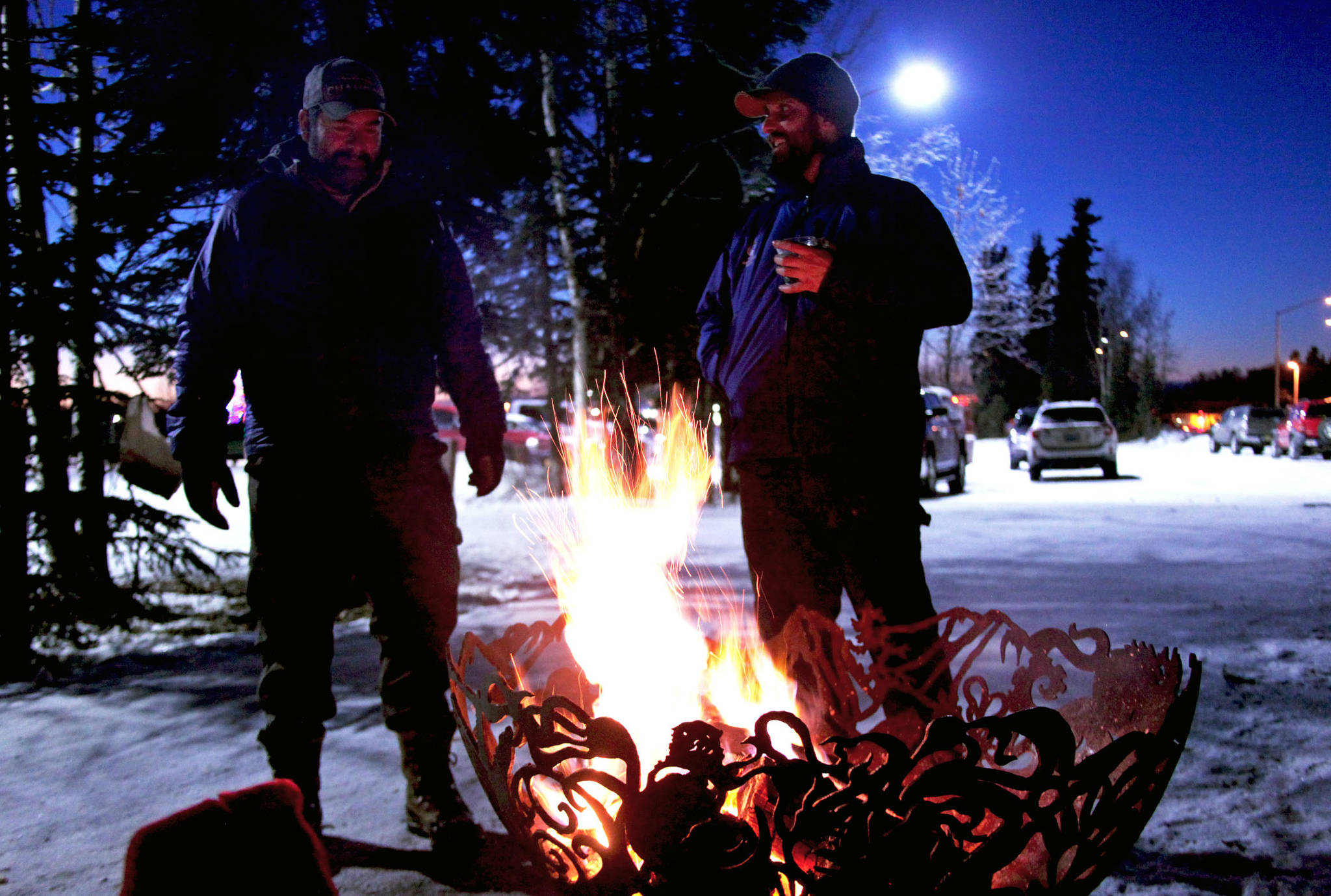 Kenai Watershed Forum water quality specialist Branden Bornemann (right) talks to a visitor during the Kenai Watershed Forum’s holiday open house Wednesday, Dec. 7, 2017 in Soldotna, Alaska. The nonprofit held a community open house at its headquarters behind Soldotna Creek Park on Wednesday night to celebrate the events of the past year. (Photo by Ben Boettger/Peninsula Clarion)