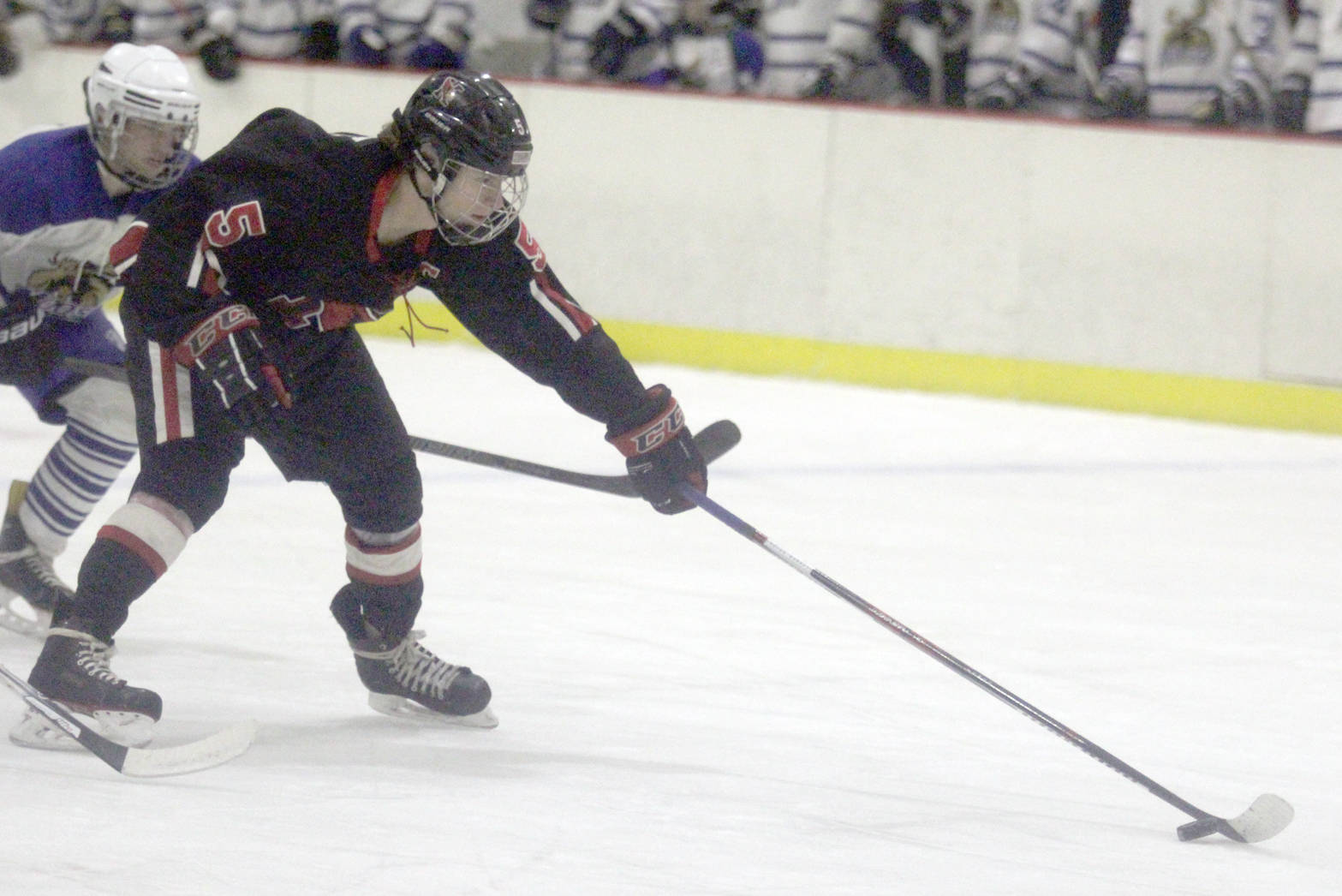 Levi Mese reaches for the puck after beating a pair of defensemen en route to a breakaway goal during a 6-5 win over Palmer in the first round of the Big Lake Christmas Classic on Thursday, Dec. 7, 2017, at the Big Lake Recreation Center. (Photo by Jeremiah Bartz/Frontiersman)