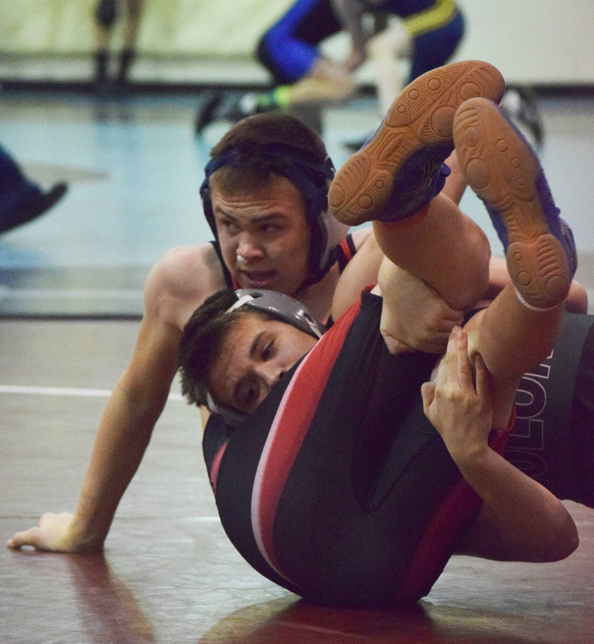 Kenai Central freshman Tucker Vann wrestles a Colony rival last Saturday at the North/South tournament at Soldotna Prep School. (Photo by Joey Klecka/Peninsula Clarion)