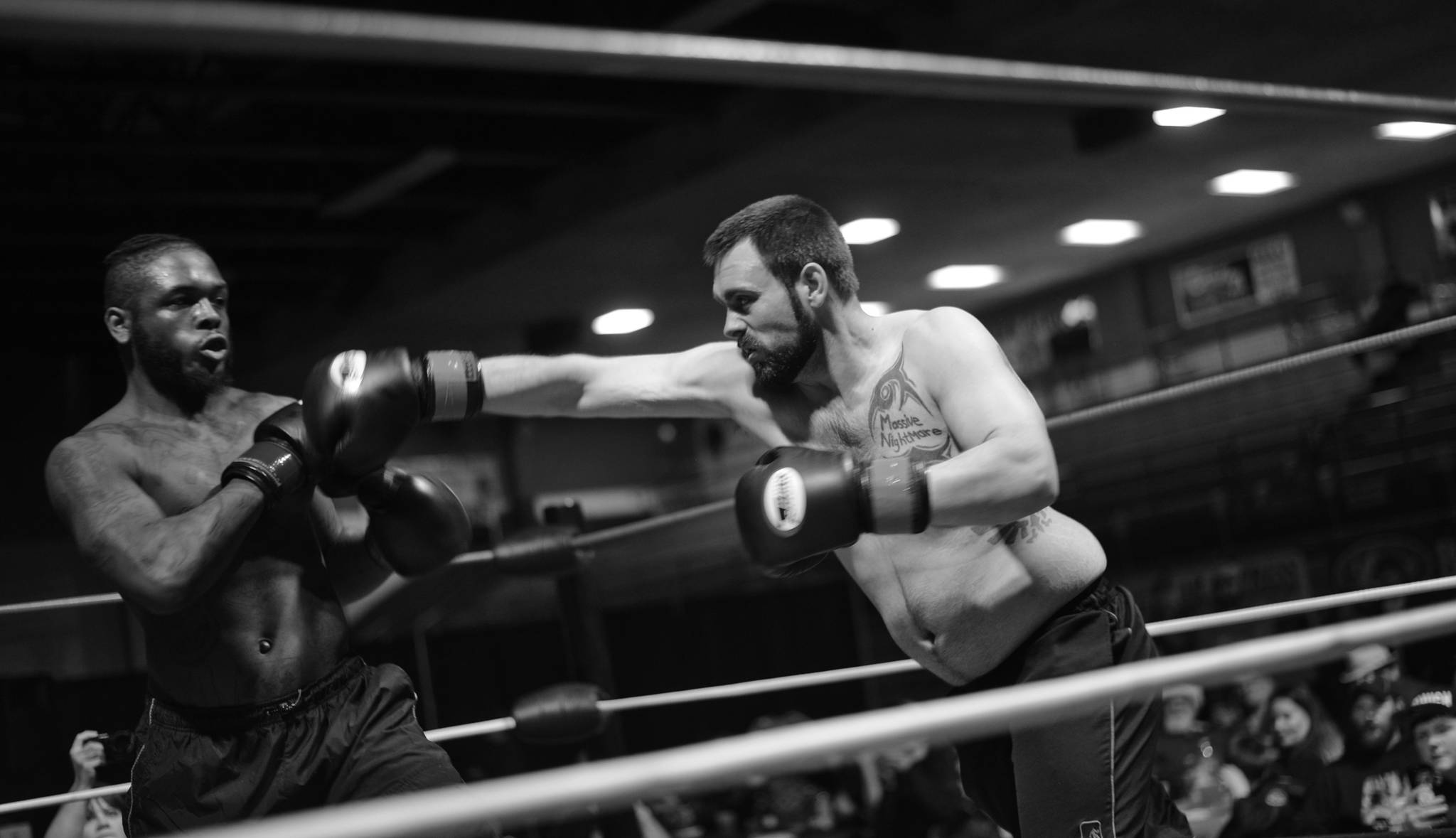 In his first match, boxer Melvin Clark, Jr., (left) evades a punch from his experienced opponent, Doug McFresh, during the Fight Before Christmas 2 matches on Saturday at the Soldotna Regional Sports Complex. Both fighters were from Nikiski. After three rounds, McFresh won. (Ben Boettger/Peninsula Clarion)