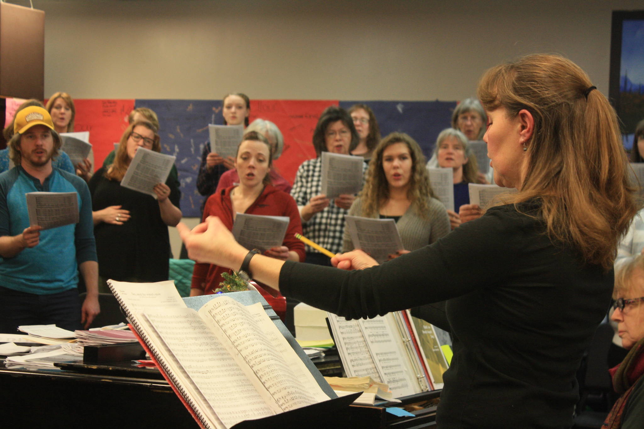 Redoubt Chamber Orchestra Conductor Tammy Vollom-Matturro leads the Kenai Peninsula Singers during a rehearsal on Dec. 11. The choir and orchestra will perform together in the 2017 Evening of Christmas on Friday, Dec. 15. (Photo by Erin Thompson/Peninsula Clarion)