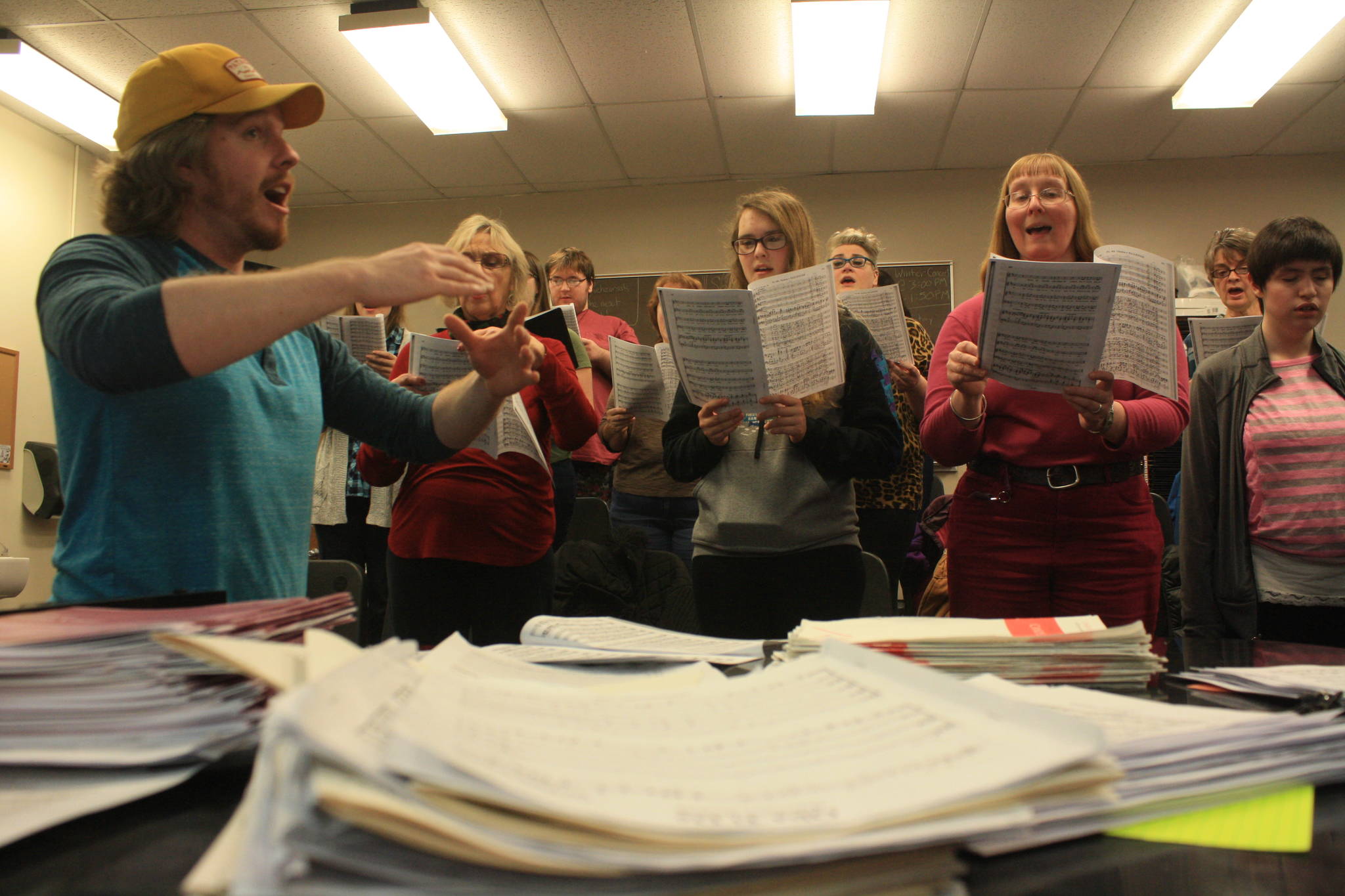 Kenai Central High choir teacher Simon Nissen conducts the Kenai Peninsula Singers during a rehearsal on Dec. 11. The Peninsula Singers and Redoubt Chamber Orchestra will perform together in the 2017 Evening of Christmas on Friday, Dec. 15. (Photo by Erin Thompson/Peninsula Clarion)