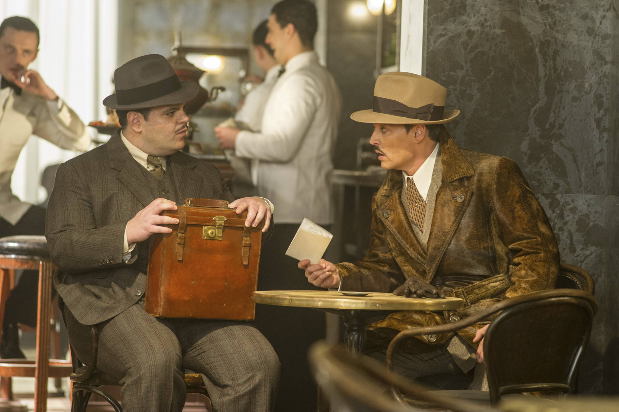 This image released by Twentieth Century Fox shows Josh Gad, left, and Johnny Depp in a scene from “Murder on the Orient Express.” (Nicola Dove/Twentieth Century Fox via AP)