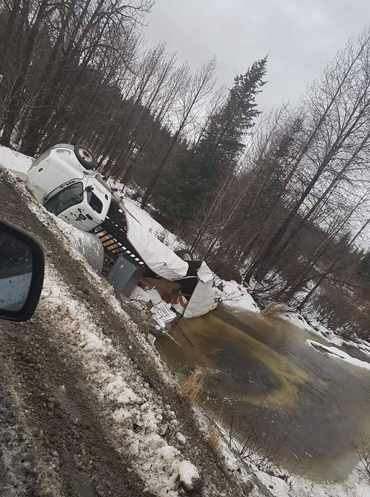 A photo provided by Cook Inletkeeper shows a Freightliner truck operated by AK Trucking that overturned on the Nikolaevsk Road near the North Fork of the Anchor River. The crash spilled an estimated 15 gallons of fuel, according to the Alaska Department of Environmental Conservation. (Photo provided, Cook Inletkeeper)