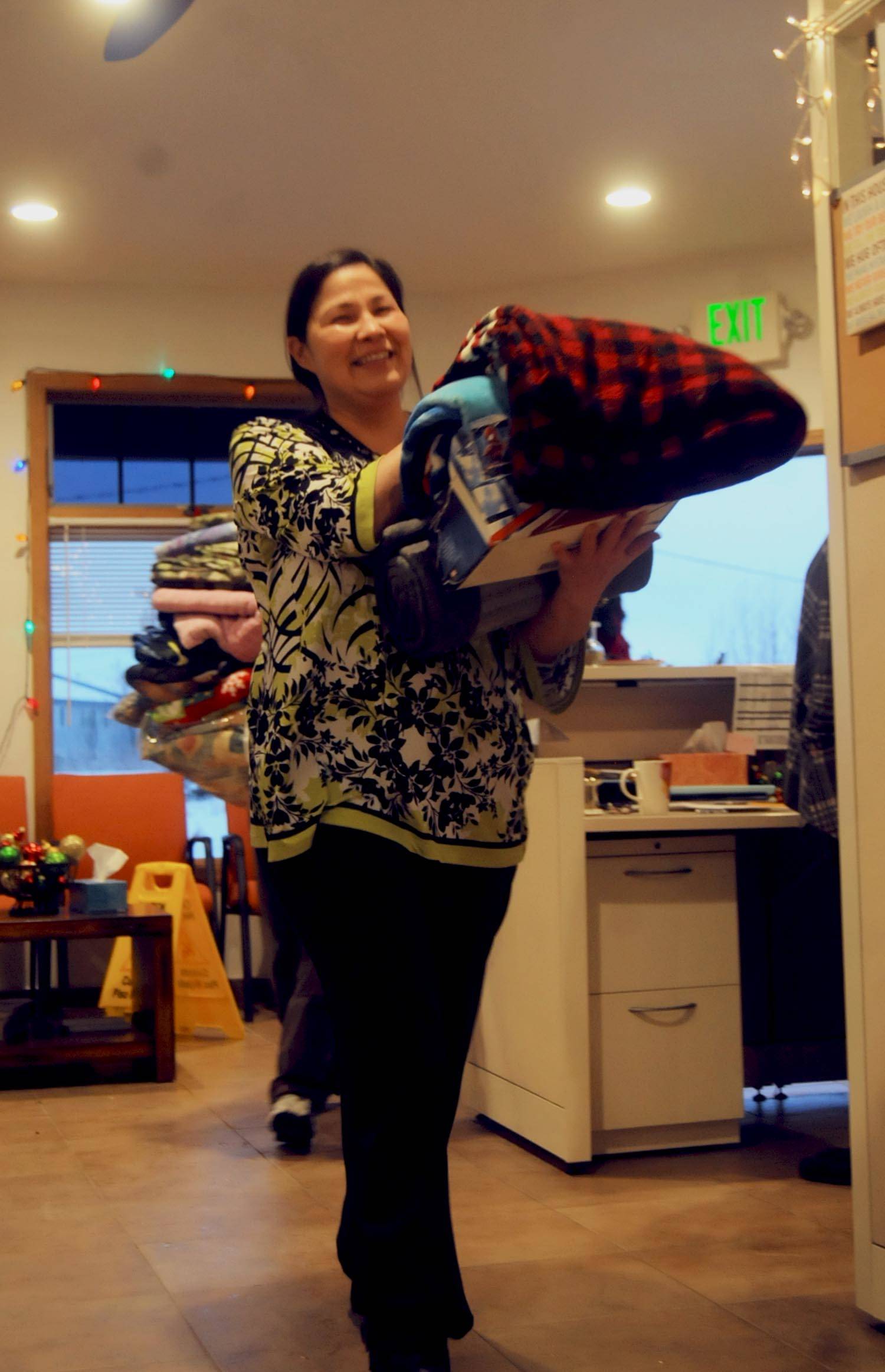 Roberta Turner of the Kenaitze Indian Tribe’s Na’ini Family and Social Services carries blankets donated by Girl Scouts Troop 254 to the center for its blanket drive. The girl scout troop, which includes 6th and 7th graders, collected blankets at Kalifornsky Beach Elementary School and Kenai Middle School to donate to the tribe. The blankets will be available for clients in need at the Na’ini Family and Social Services building and some will be distributed at the Project Homeless Connect event in January 2018. (Photo by Elizabeth Earl/Peninsula Clarion)