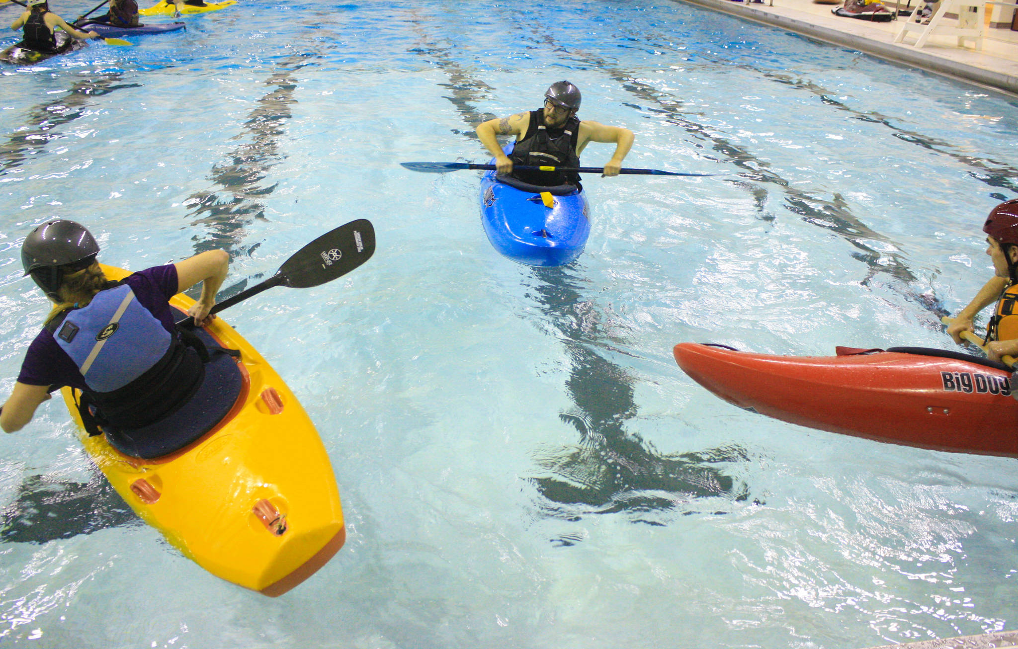 Kayakers take instruction from Matthew Pyhala, owner of the Immersion Paddling Academy, during a Dec. 13 training session at the Skyview pool. (Photo by Erin Thompson/Peninsula Clarion)