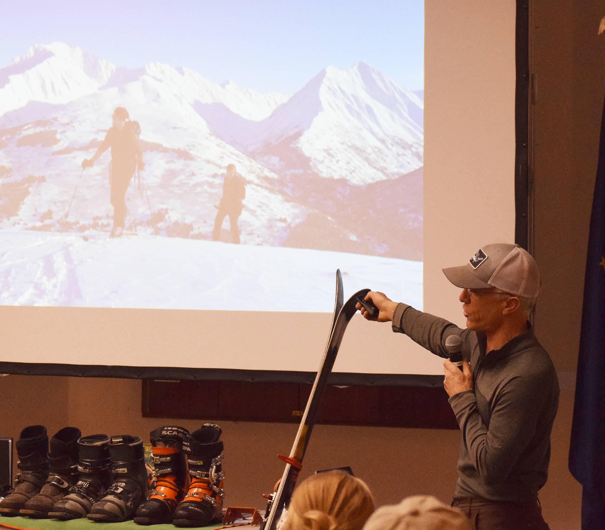 Tony Doyle points out the finer details in a photo presentation Dec. 20 at the Kenai Visitors and Cultural Center. (Photo by Joey Klecka/Peninsula Clarion)